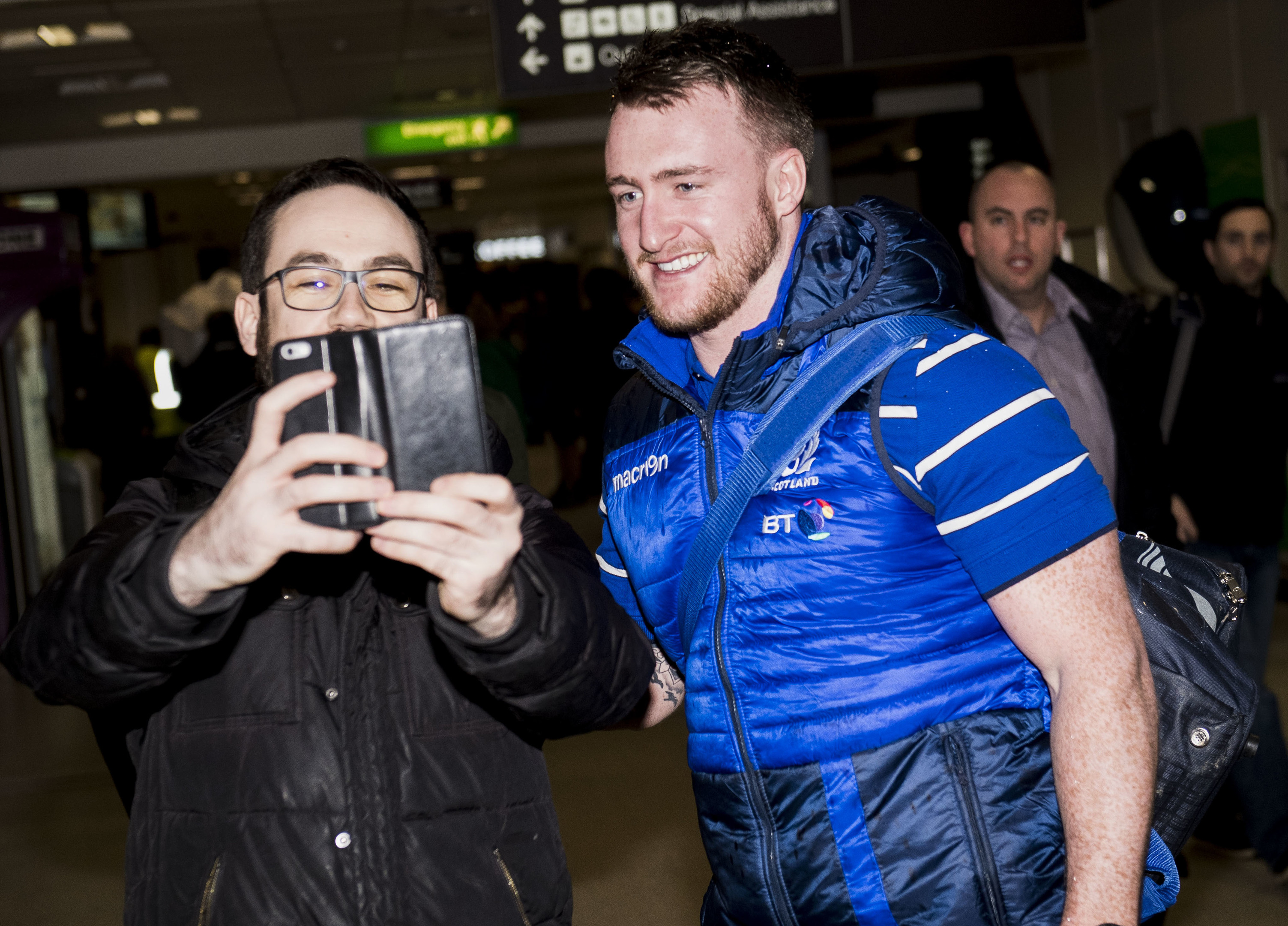 Stuart Hogg, who wins his 50th cap against France, shares a selfie with a fan at Edinburgh Airport.