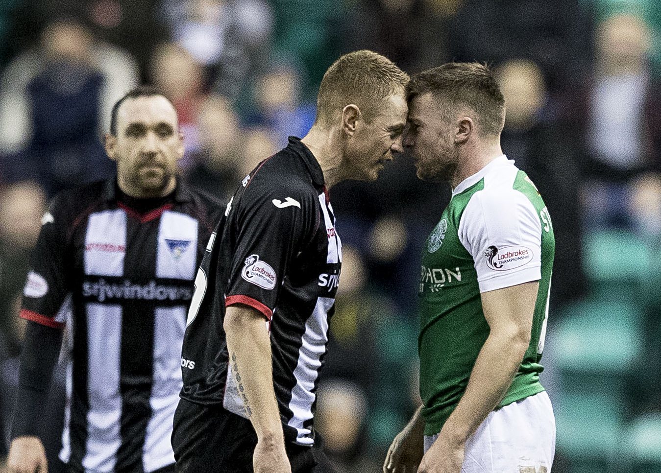 Andy Geggan gets up close with Hibernian's Lewis Stevenson.