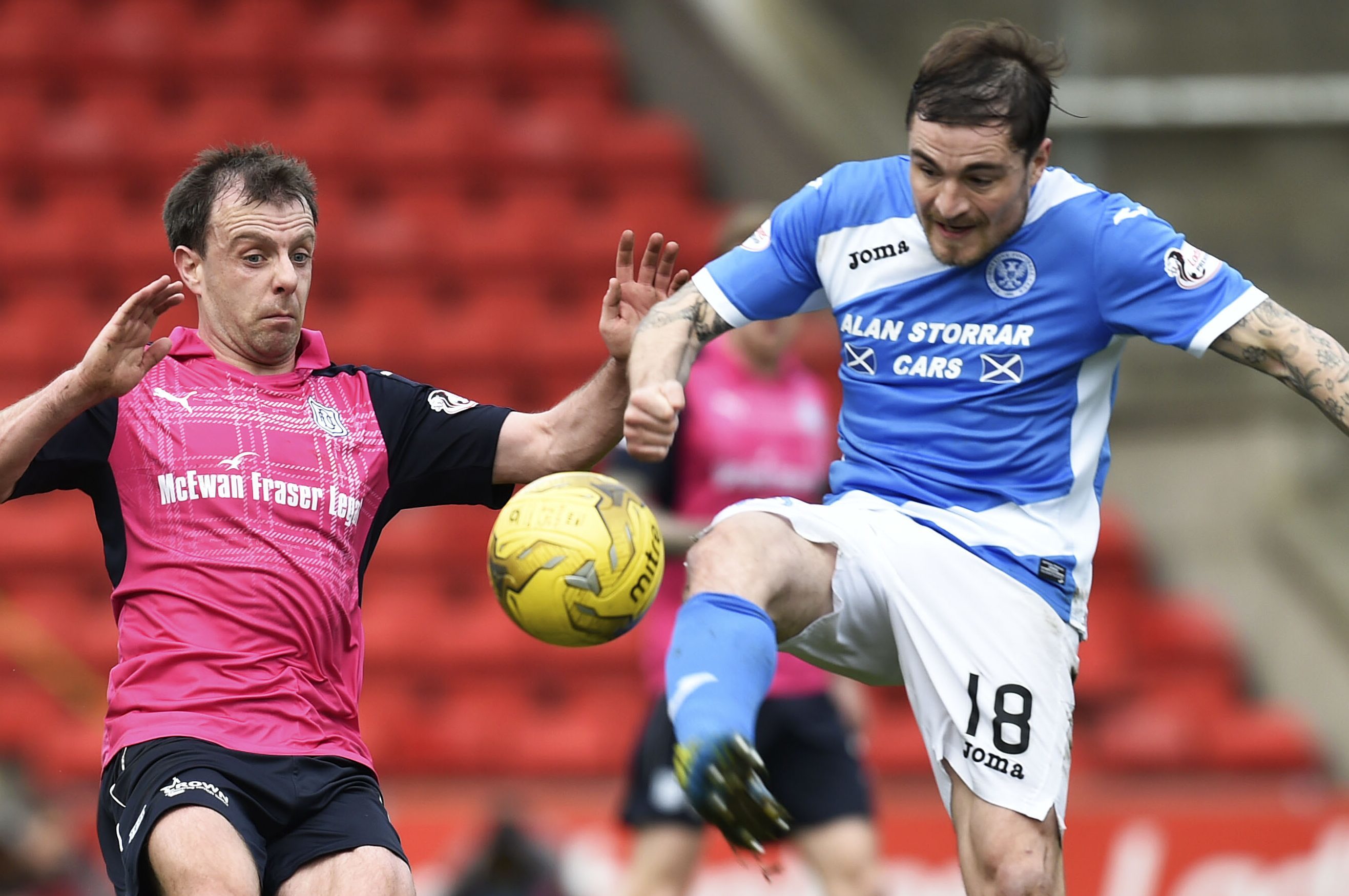 Paul Paton battles for the ball with Dundee's Paul McGowan.