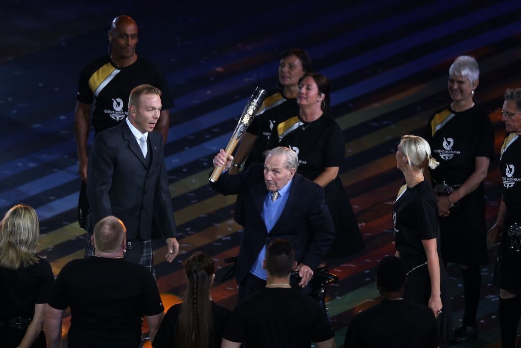 Sir Chris Hoy waits to receive the baton from his great uncle Andy Coogan.