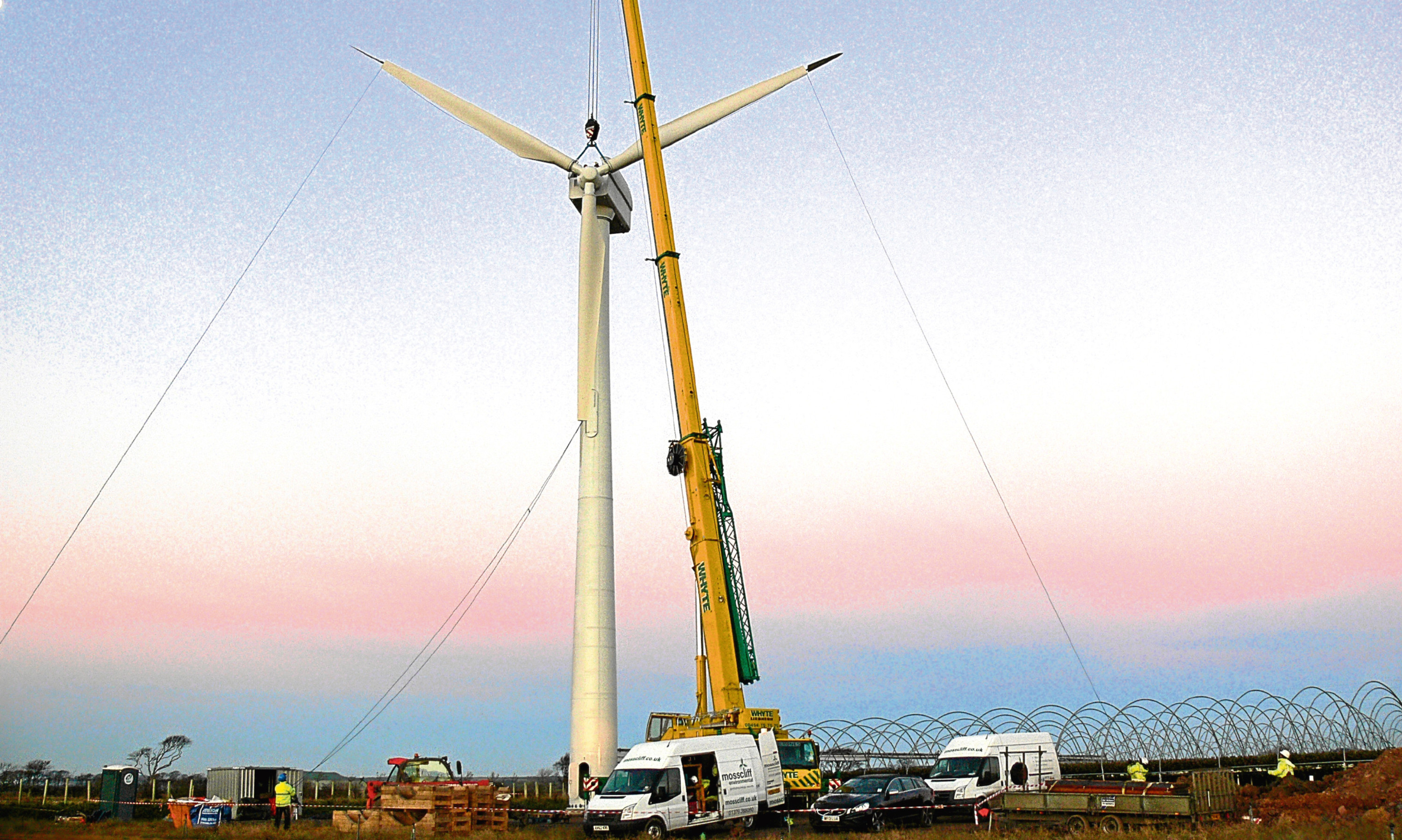 Blades being attached to an onshore wind turbine