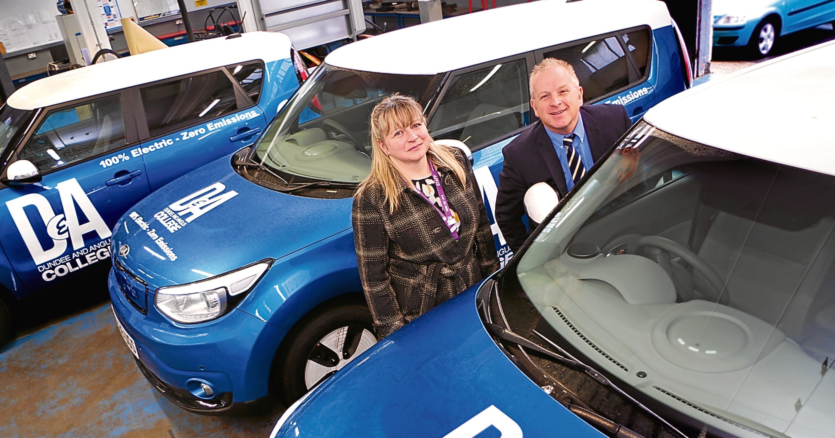 Environmental officer Jackie Beresford and Billy Grace, head of estates, with the cars.