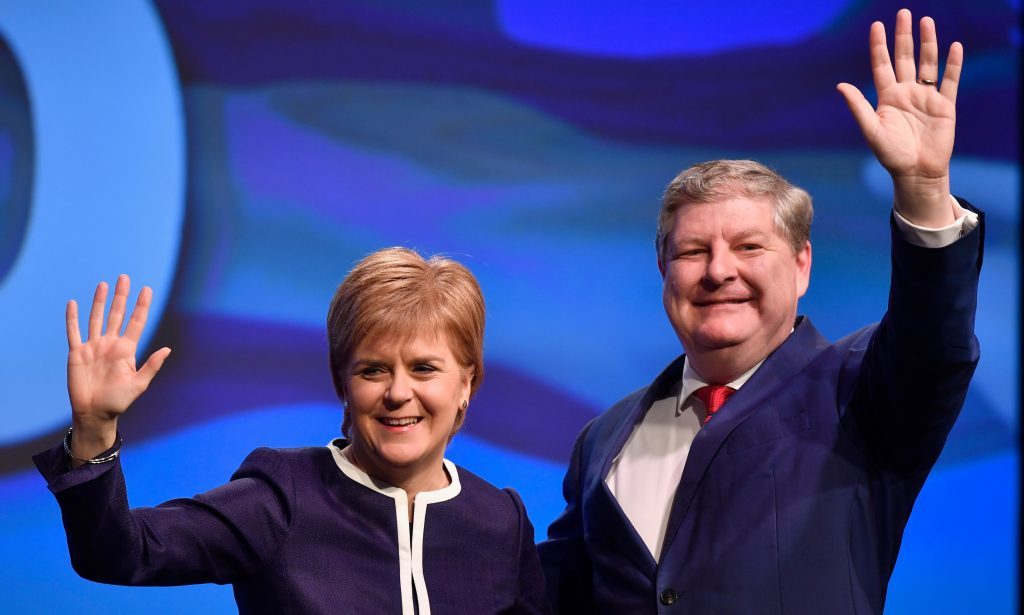 First Minister Nicola Sturgeon and Angus Robertson, deputy SNP leader, acknowledge applause after addressing delegates at the SNP spring conference.