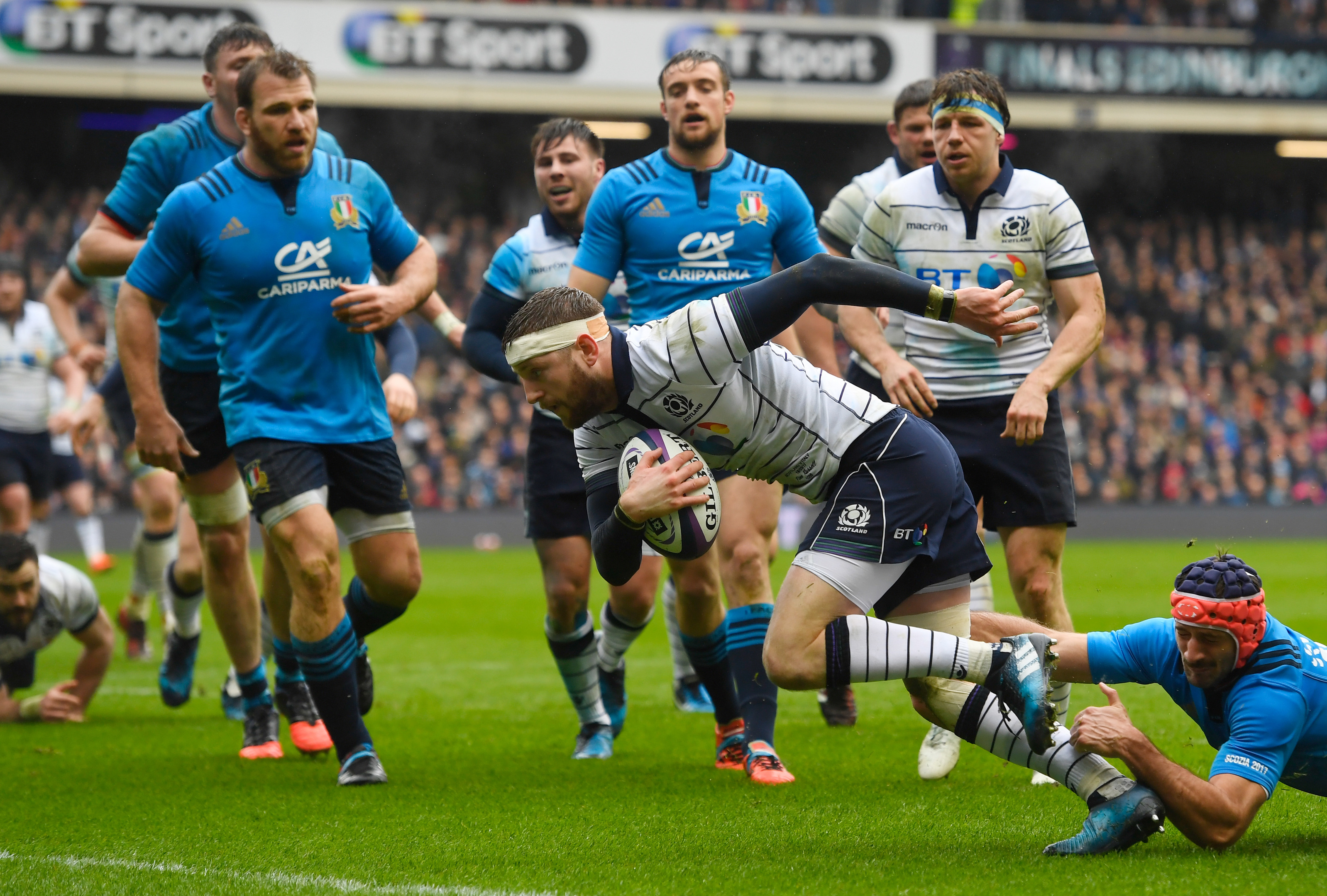 Finn Russell scores against Italy at Murrayfield last year.