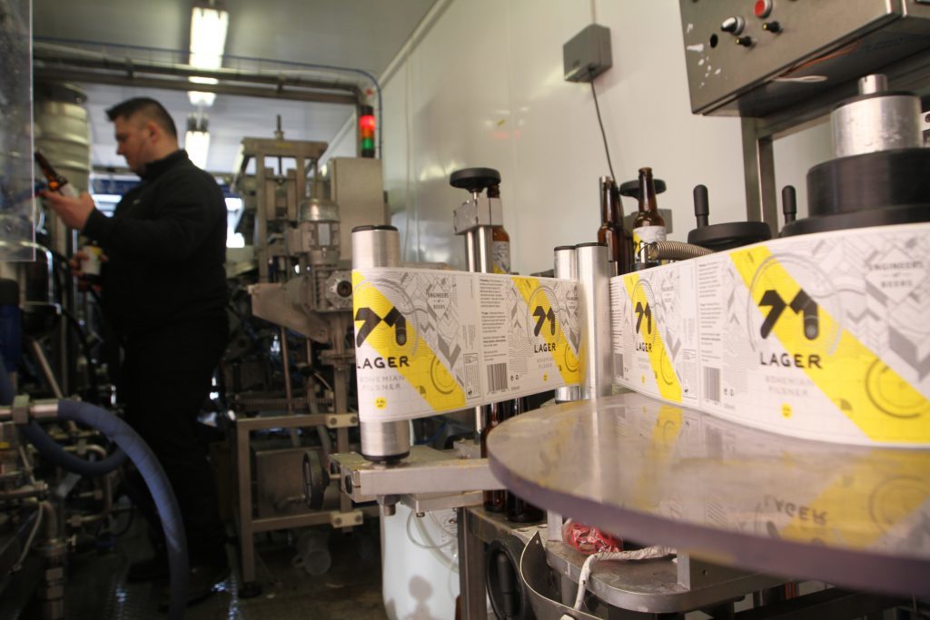 The bottles being labelled in the factory.