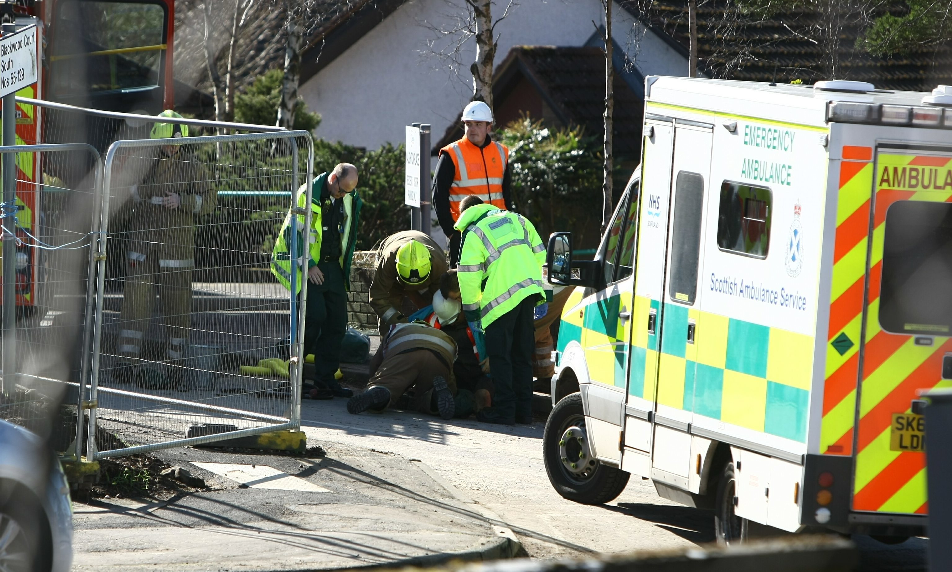 Fire and rescue staff try to free the trapped worker.