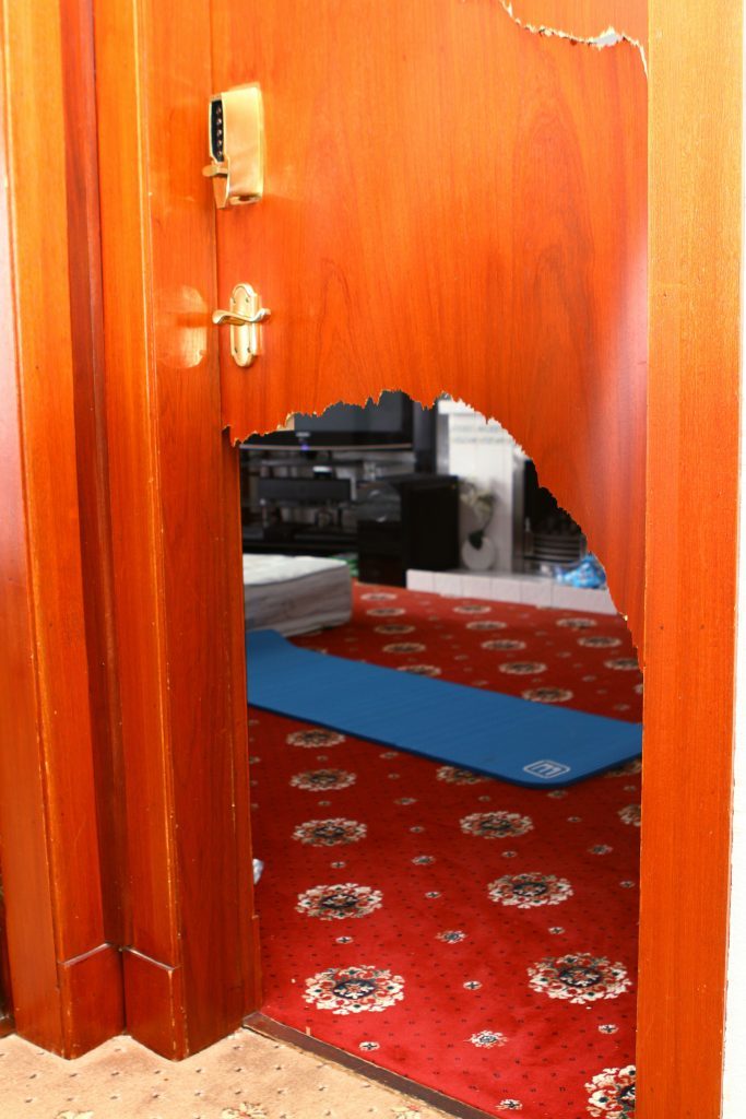 The living room door was smashed by the thieves as they gained entry to the interiror of the house