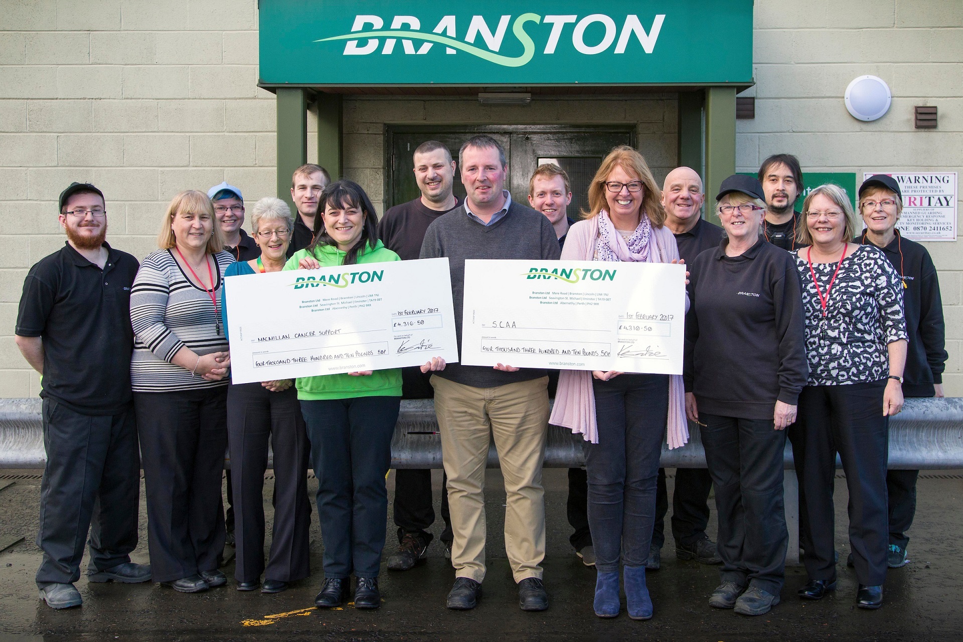 General Manager, Kevin Imrie presenting cheques to Isla Dewar from Macmillan Cancer Support and Fiona Dennis from SCAA.