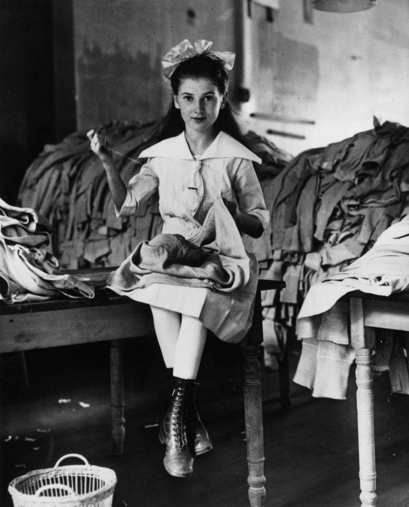 A young American girl repairing army uniforms during the First World War. (Photo by Keystone/Getty Images)