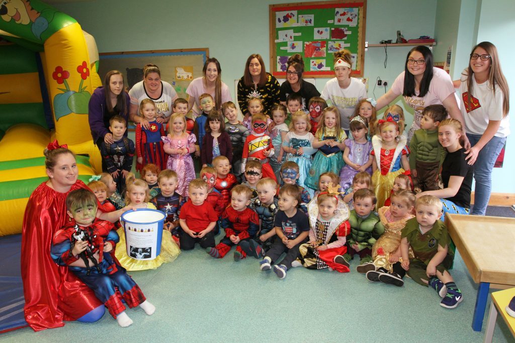 Joanne Mackie (front left) holding Mike's son Rocco with the other children and staff.