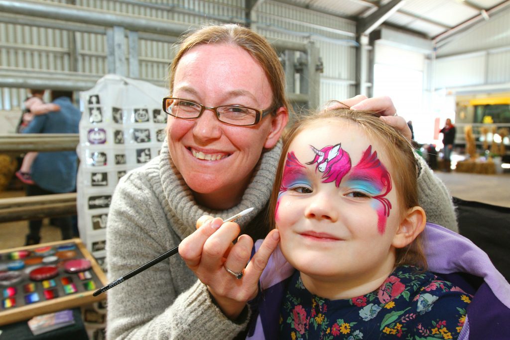 Lauren Whiteside, 4, from Monikie, getting her face painted by Marley Hunter of Put on a Happy Face.
