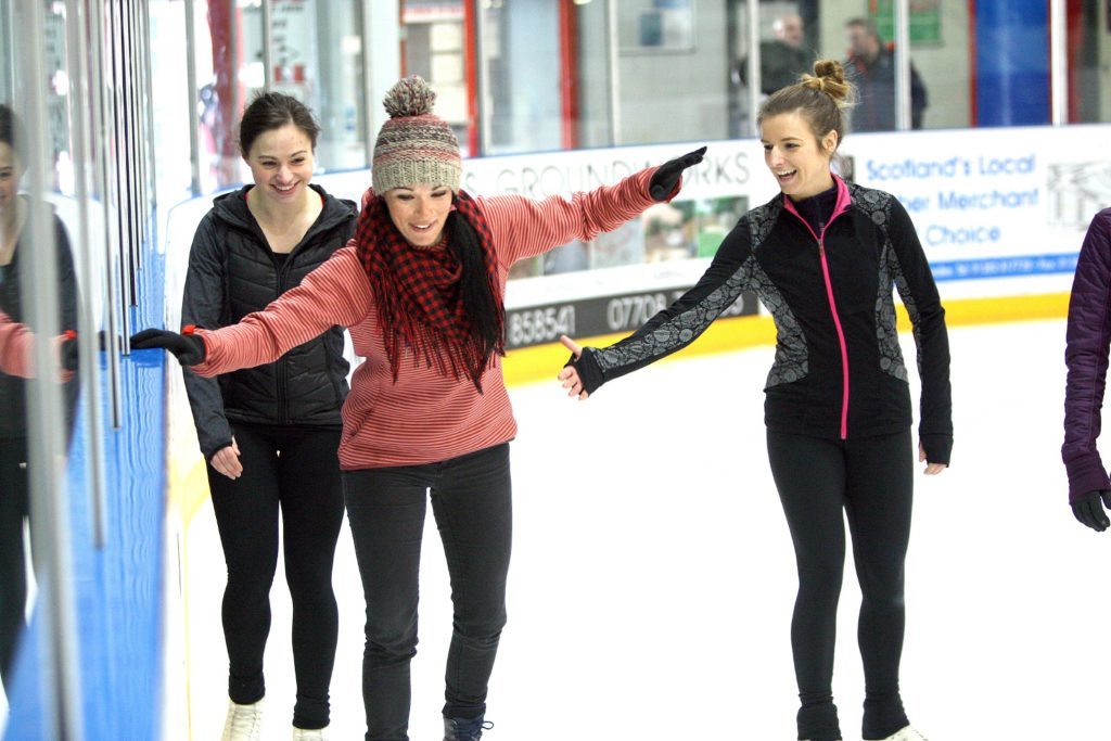 Gayle under tuition on the ice. 