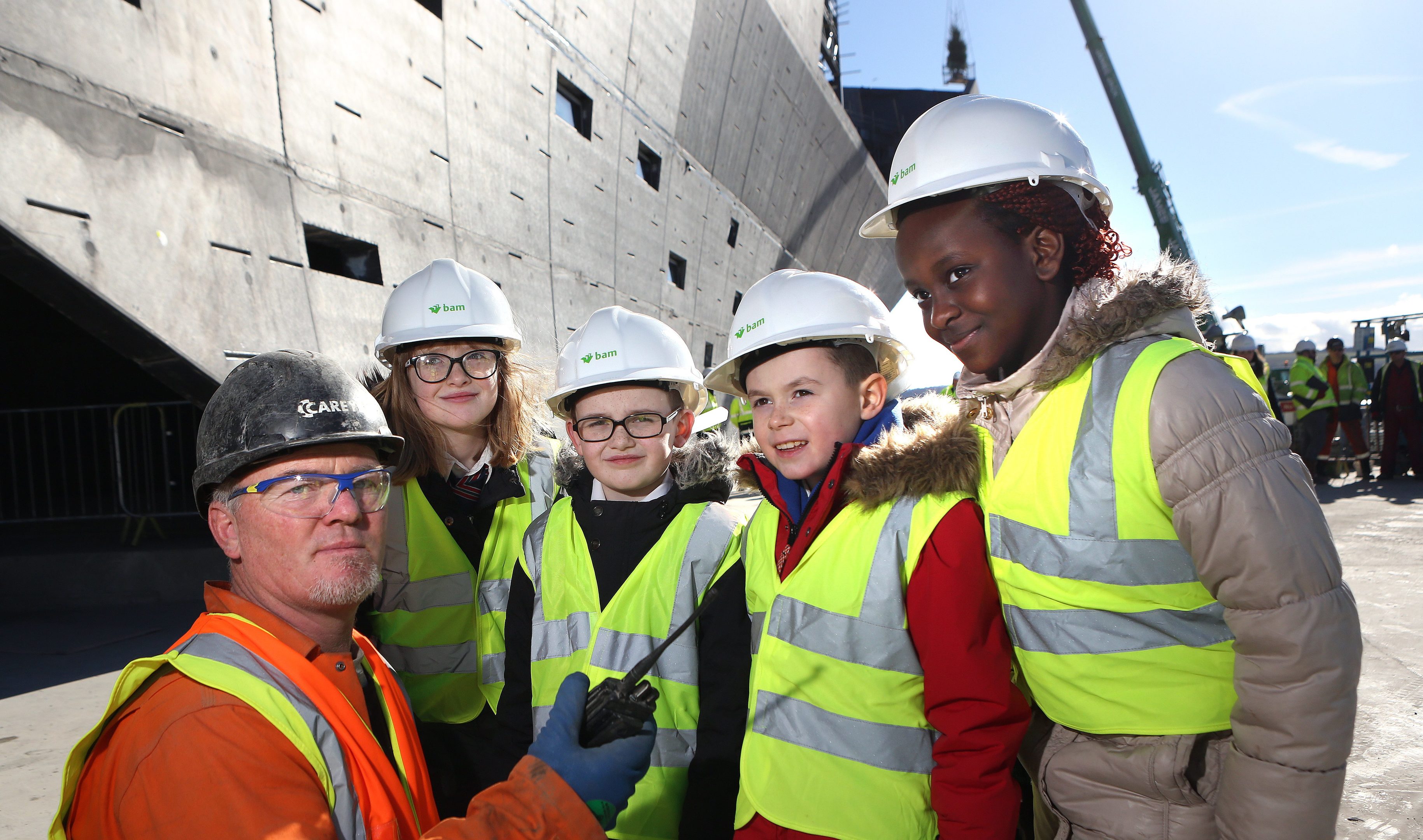 Sarah McGillivary, Dominic Nelson (both Rosebank Primary) and Jak Adams and Fiona Okeke (both Our Lady's) starting the topping off ceremony over the radio with foreman Sean McGee.