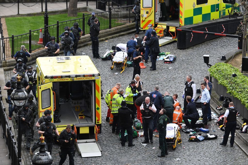 Paramedics treat wounded even as anti-terror police take up positions.