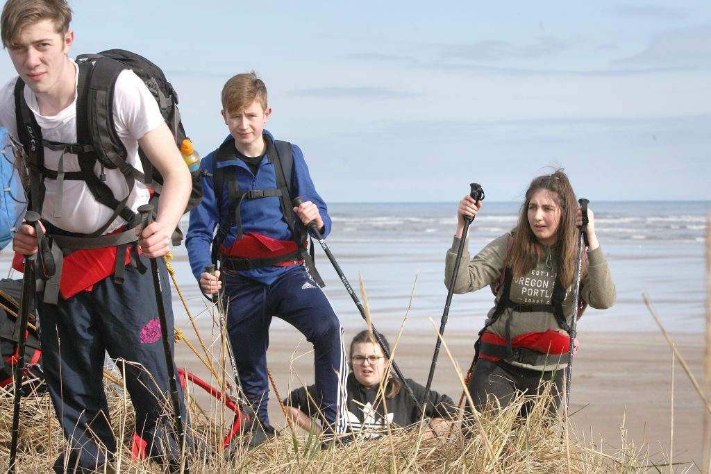 Tough at the top. The kids have to drag tyres up and down sand dunes during training.