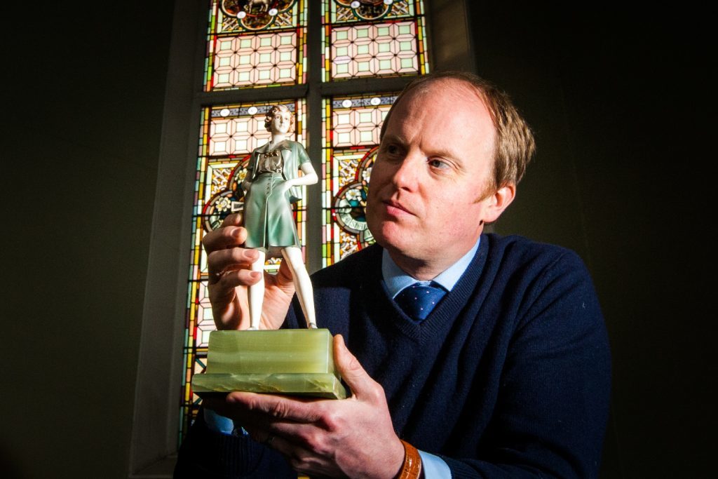 Nick Burns with an art deco bronze sculpture up for auction. 