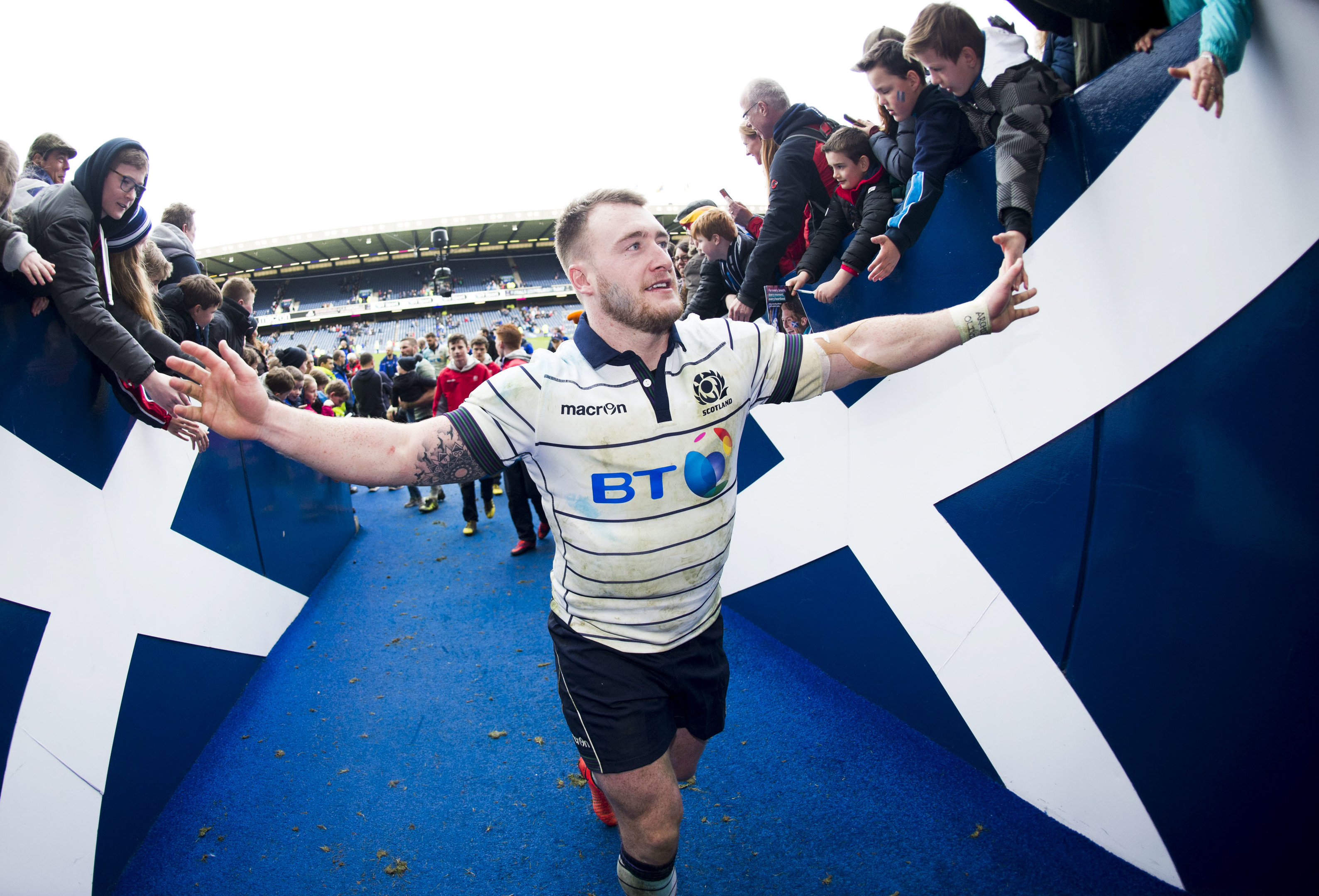 Stuart Hoggtakes the congratulations of Scotland fans as he leaves the field after the win over Italy.