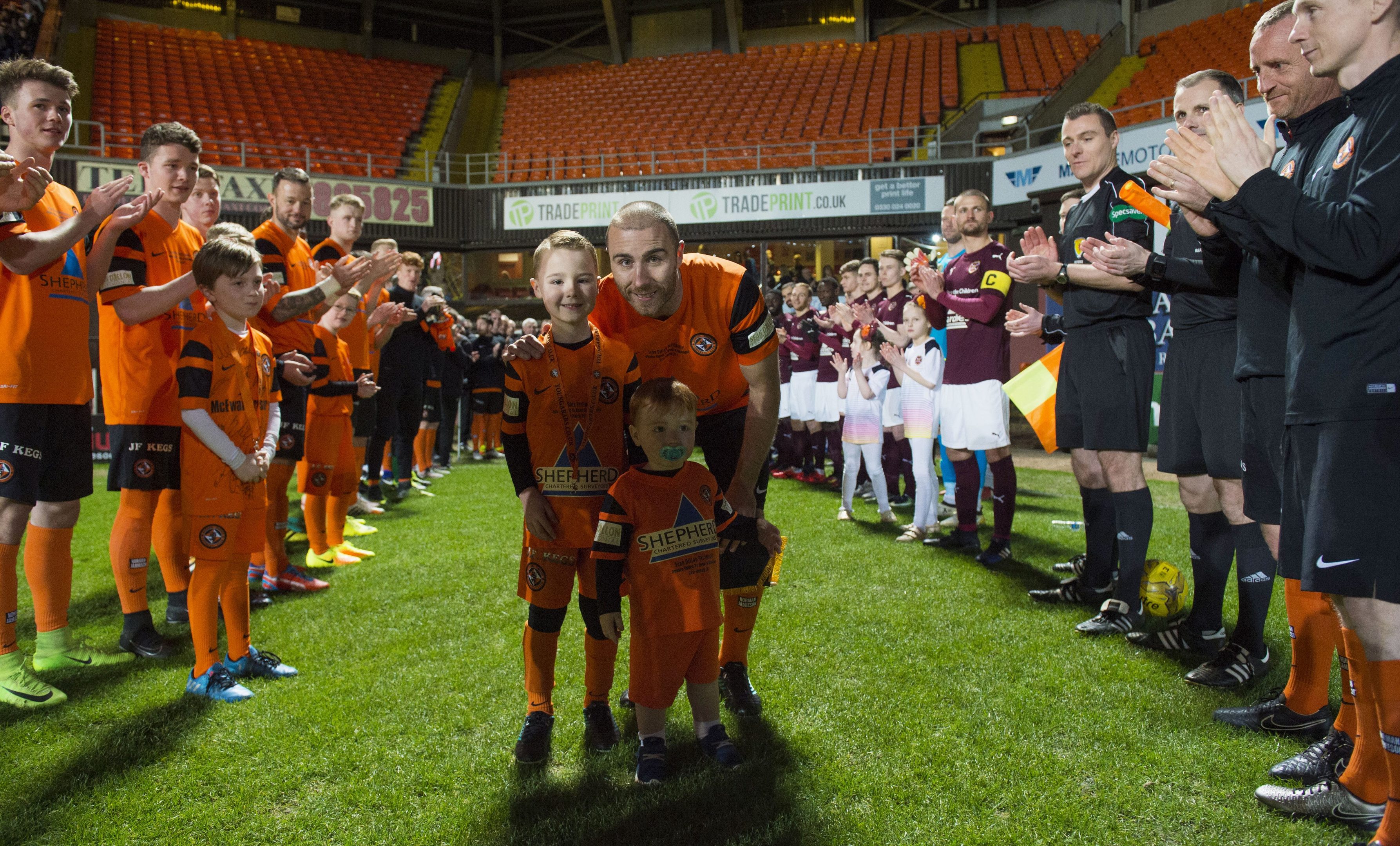 Sean Dillon walks out with his kids to a guard of honour at his testimonial match