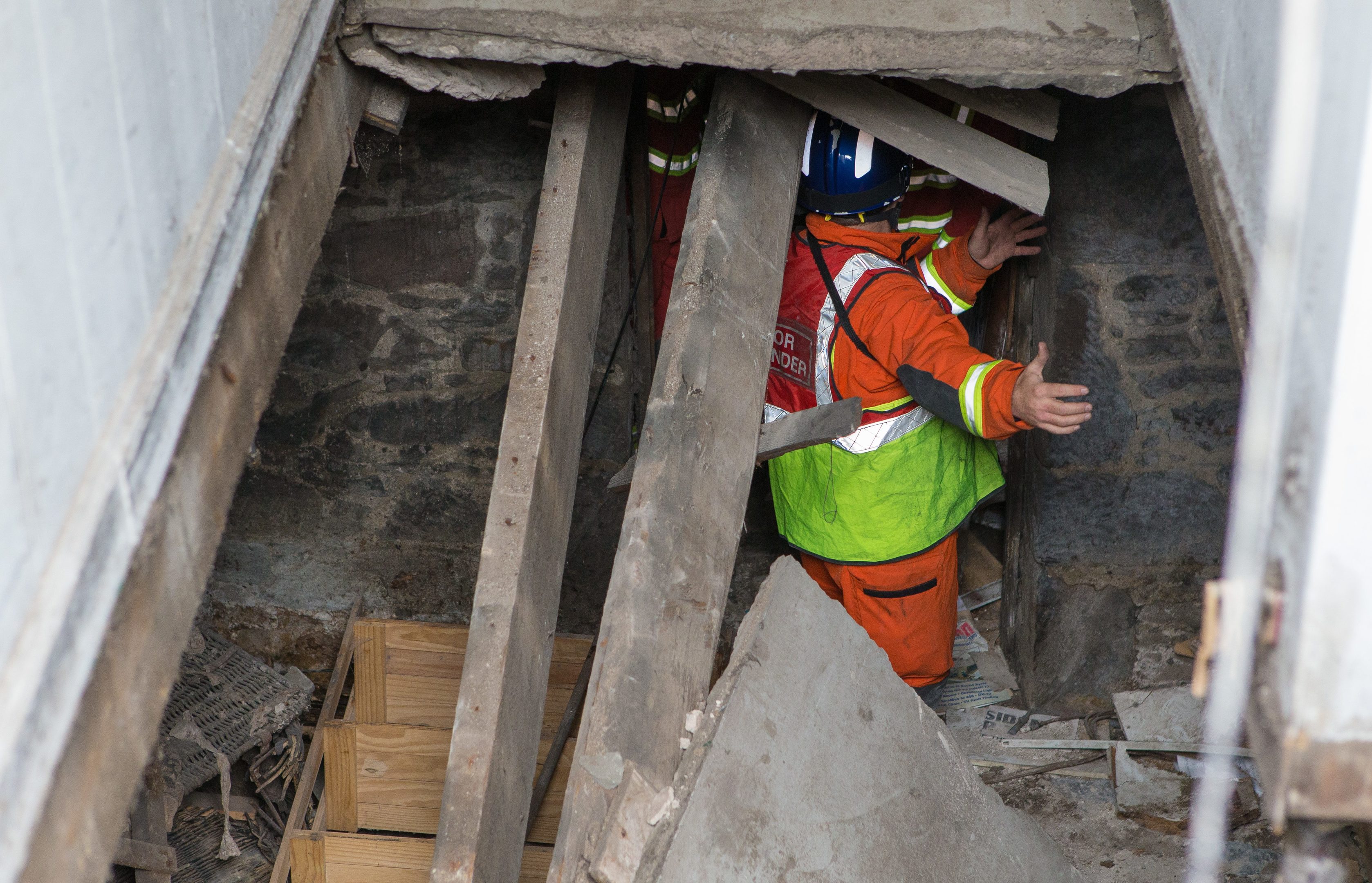 Emergency services examining the collapsed stairwell.