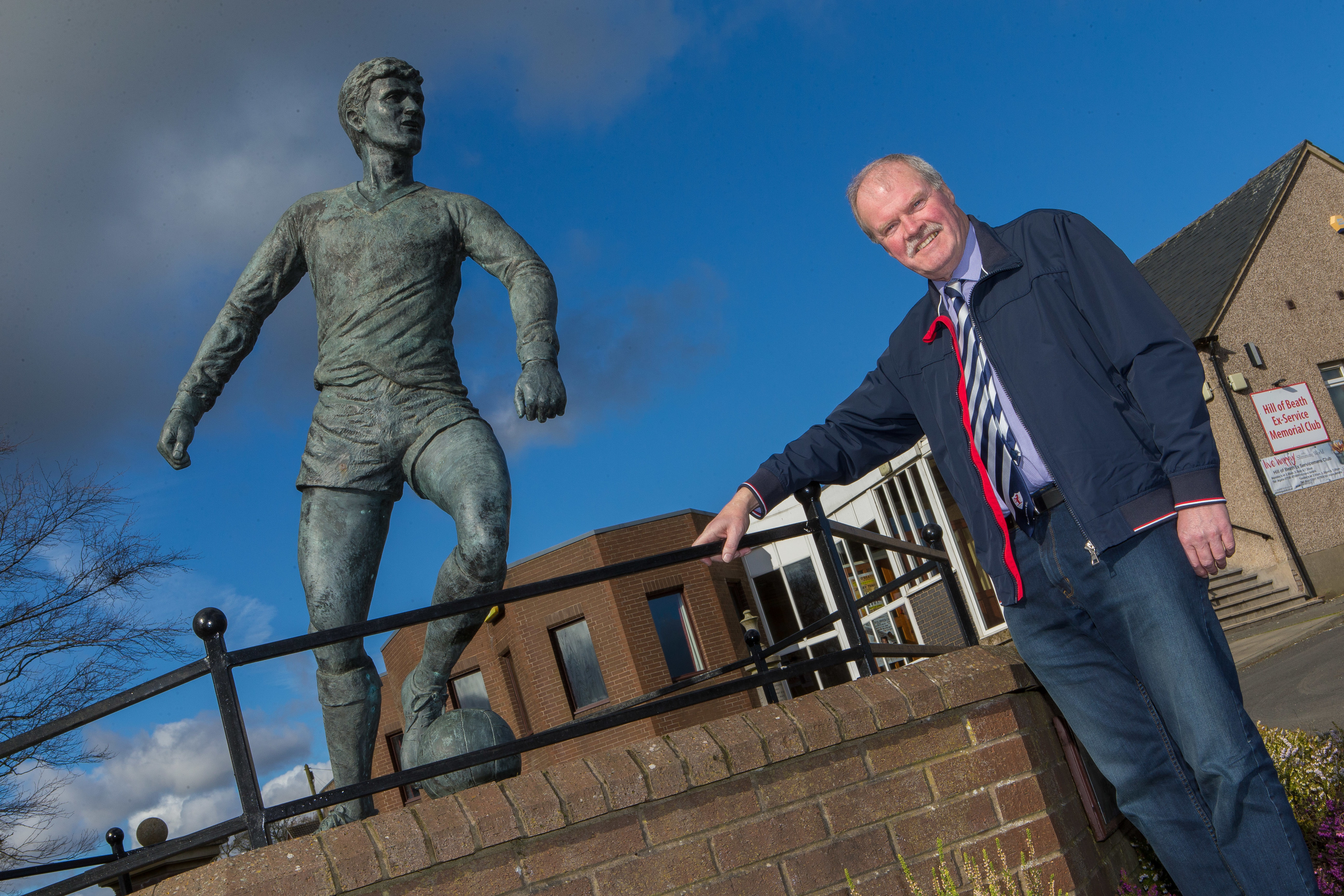 Raith director Dave Wann alongside the famous statue of Jim Baxter in Hill of Beath.