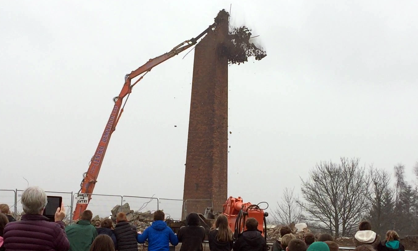 The chimney is brought down chunk by chunk.