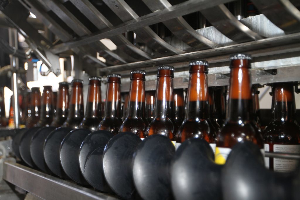 Details of the bottles being filled and processed for shipping.