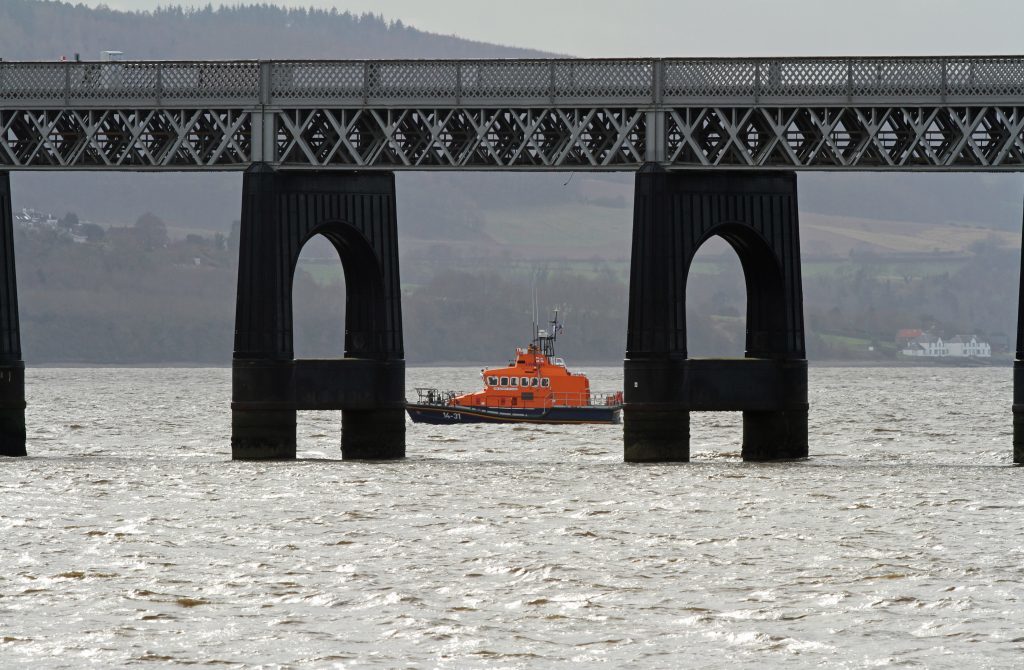 The Broughty lifeboat scours the area around the rail bridge.