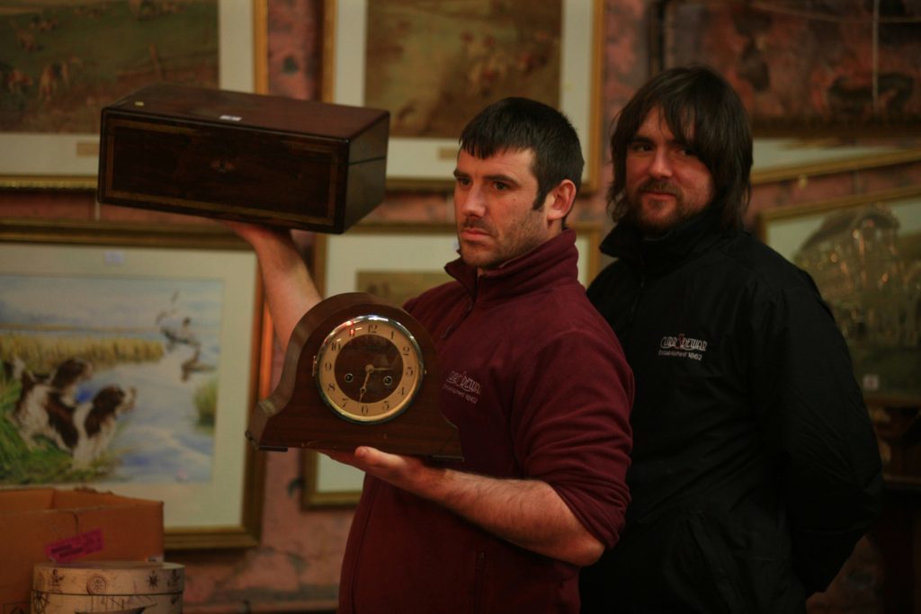 Richie Stewart shows off a clock to bidders at Curr and Dewar's auction house in Dundee.