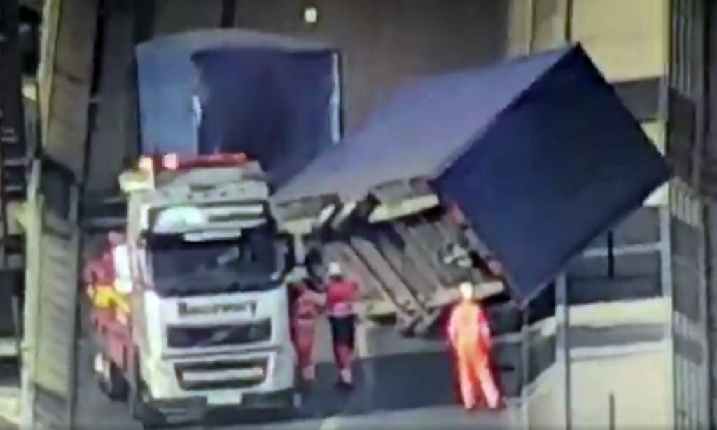The effort to remove the lorry and trailer has been hampered by continuing high winds.