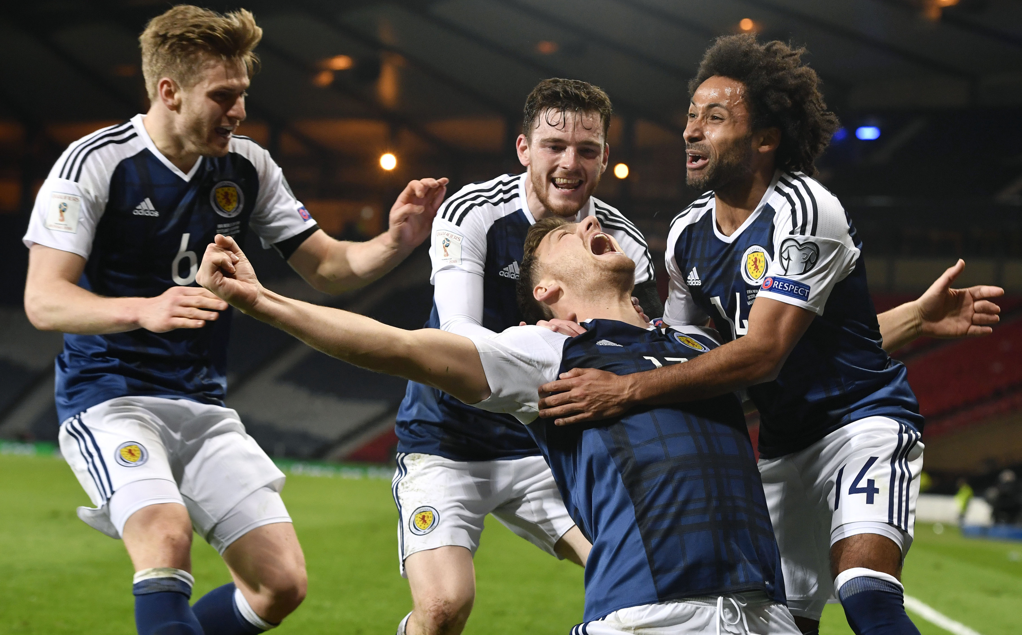 Scotland's Chris Martin celebrates his late goal with his team mates.