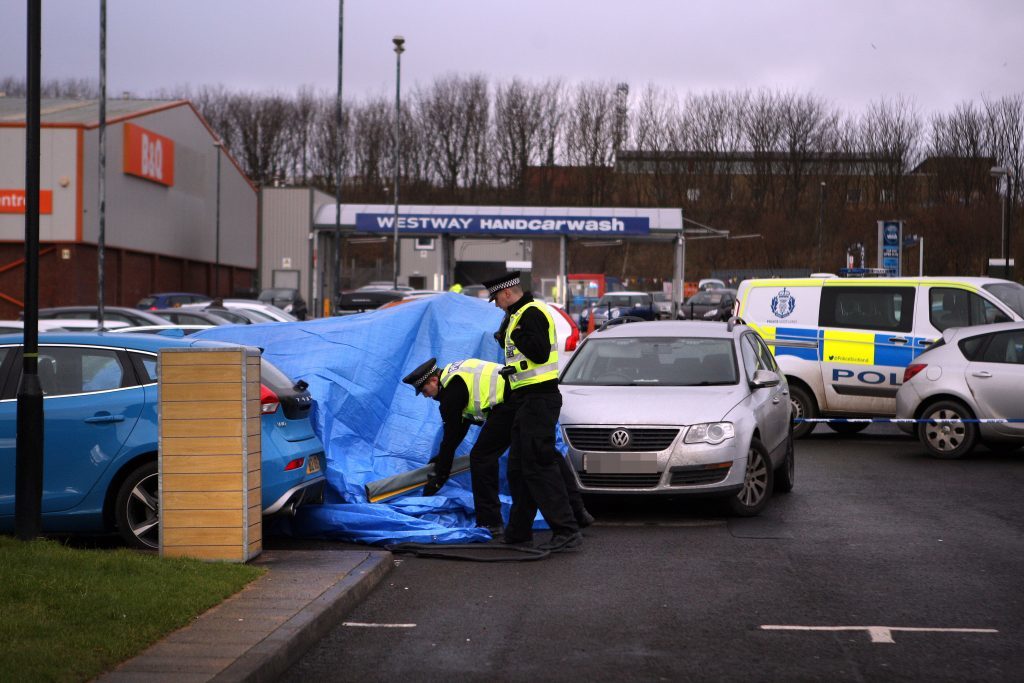 The tarpaulin-covered Mercedes in the McDonalds car park.