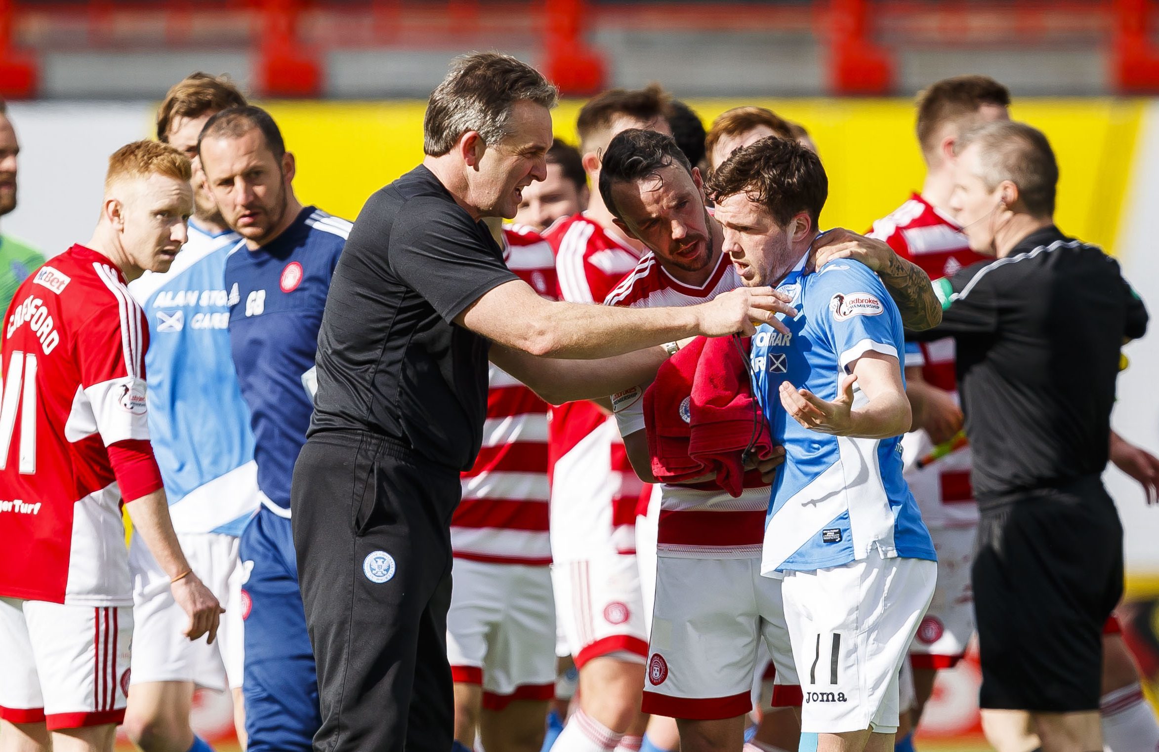 The half-time scene as Saints staff and Hamilton players attempt to calm Danny Swanson.