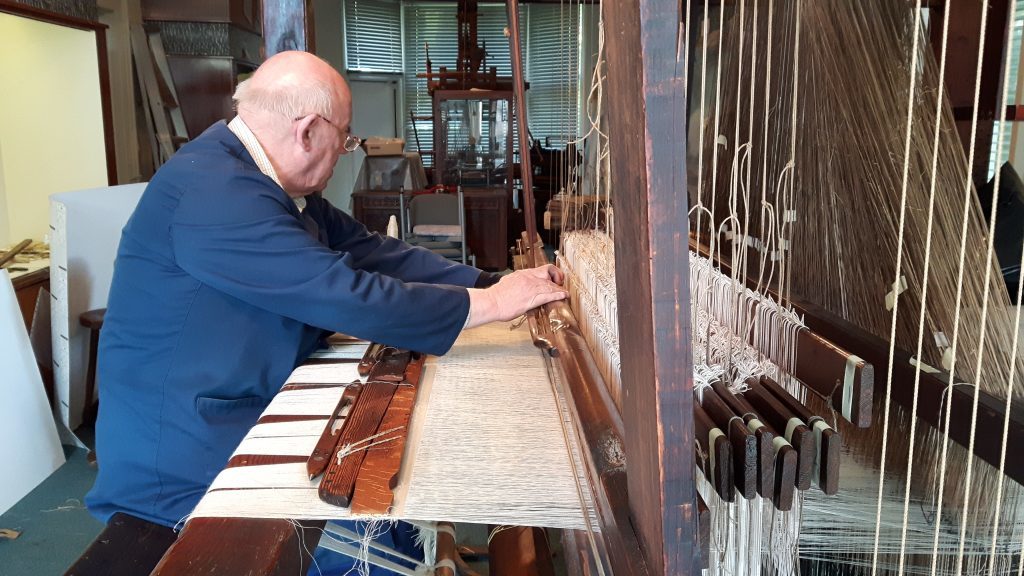 Ian Dale operating the historic loom.