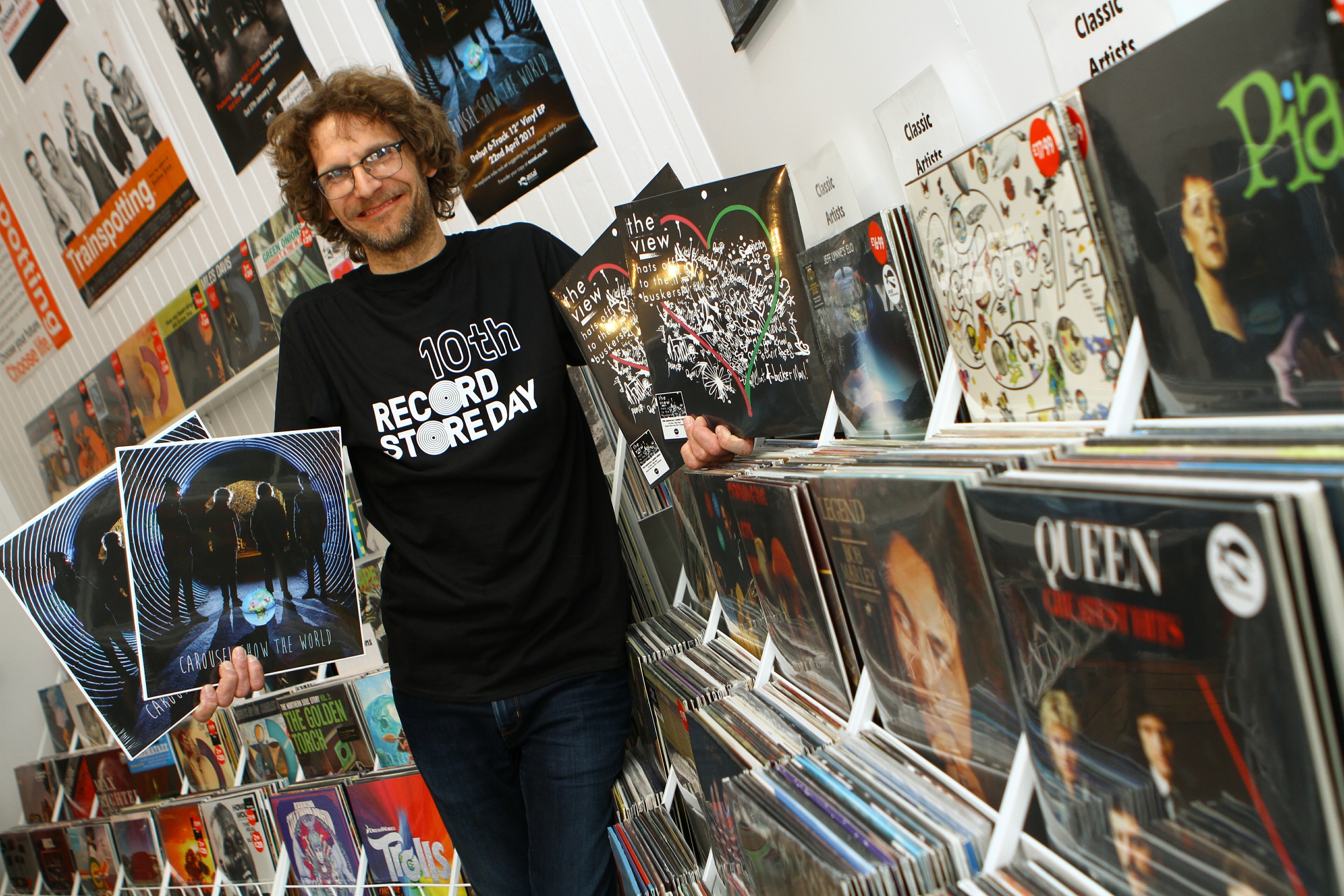 Andy McLaren - Manager of Assai Records in Broughty Ferry, holding copies of two exclusives, on the left, Carousel - Show The World, the first recording on the  Assai label, and The View - Hats Off To The Buskers.