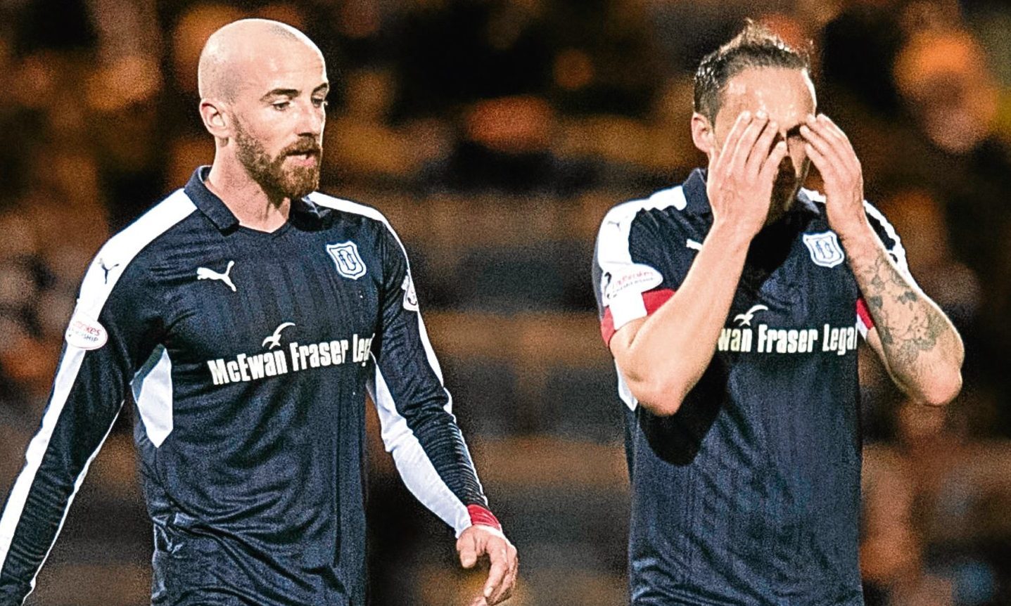 Dundee players James Vincent and Tom Hateley show their feelings after going 0-7 down to Aberdeen.