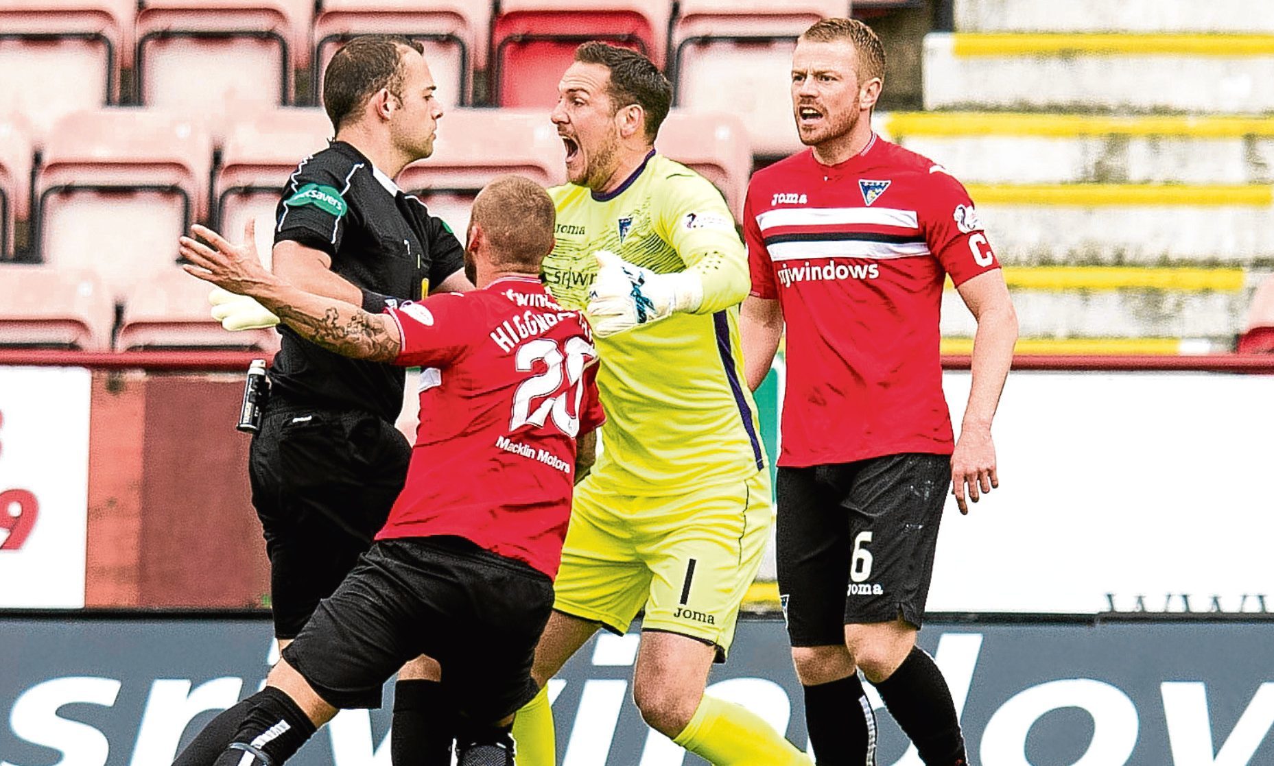Dunfermline players contest the penalty decision.