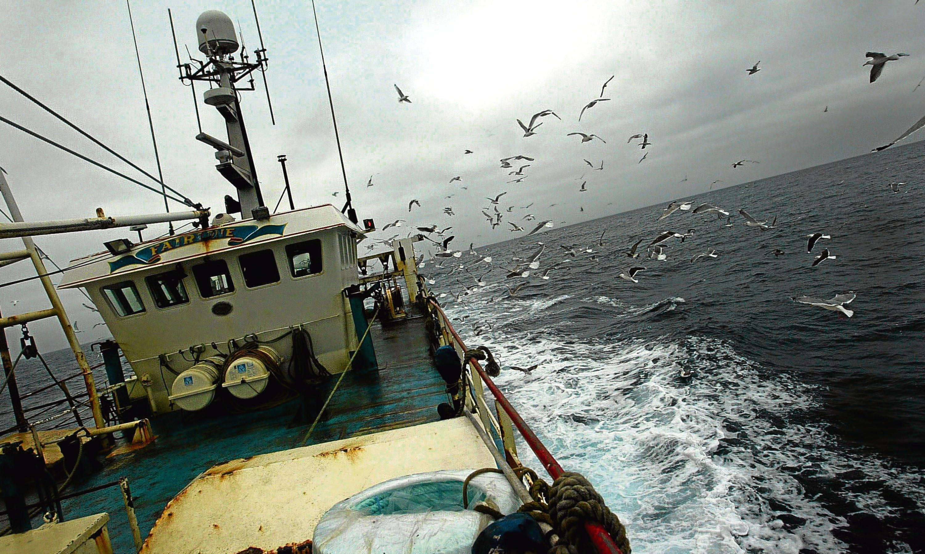 A Scottish fishing boat leaves port for the North Sea fishing grounds.