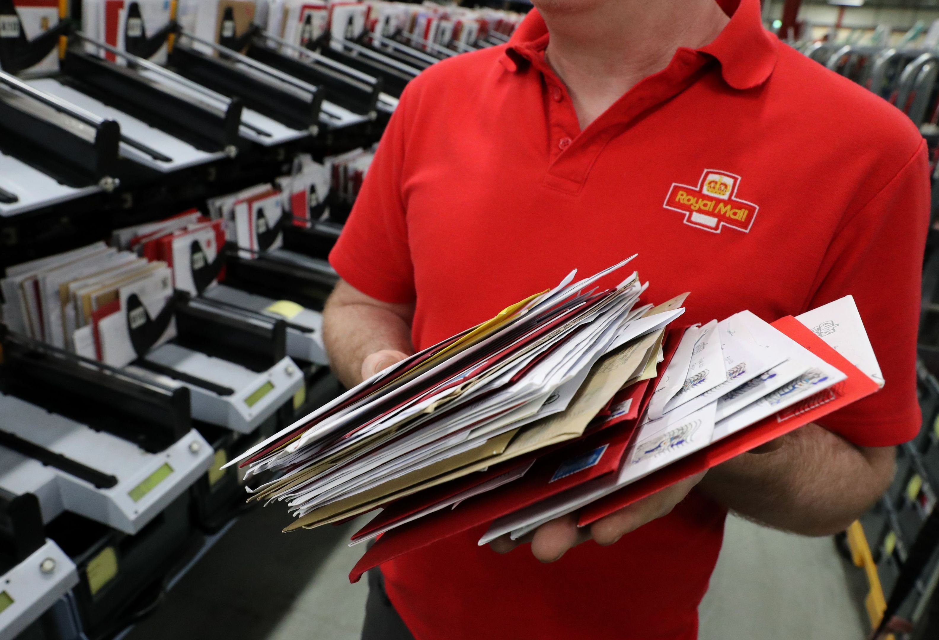 Sorting mail at a Royal Mail depot - the company plans to axe thousands of jobs.