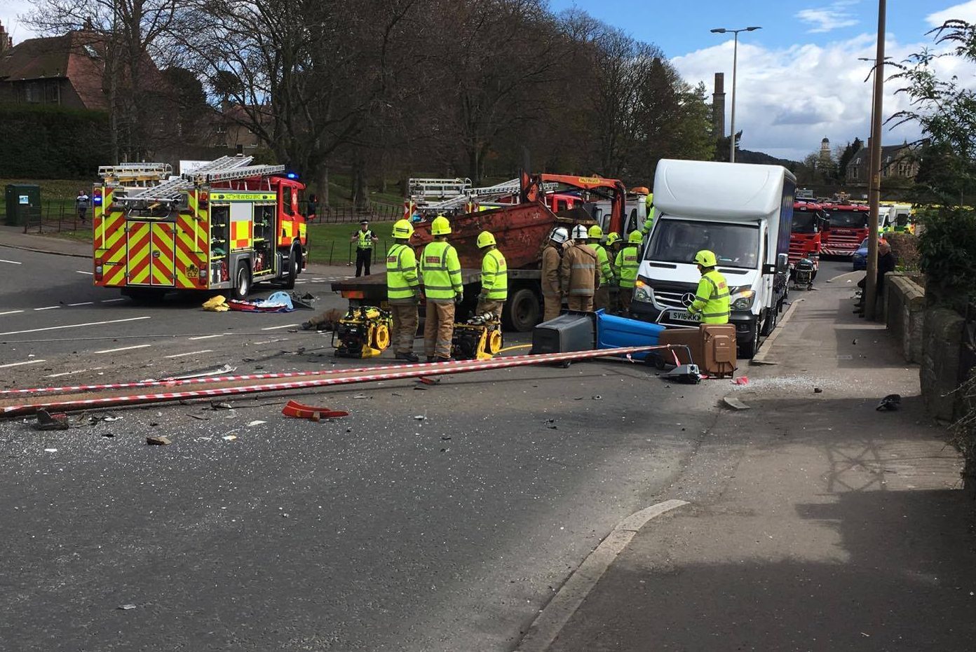 Firefighters working to rescue the driver of the skip lorry.