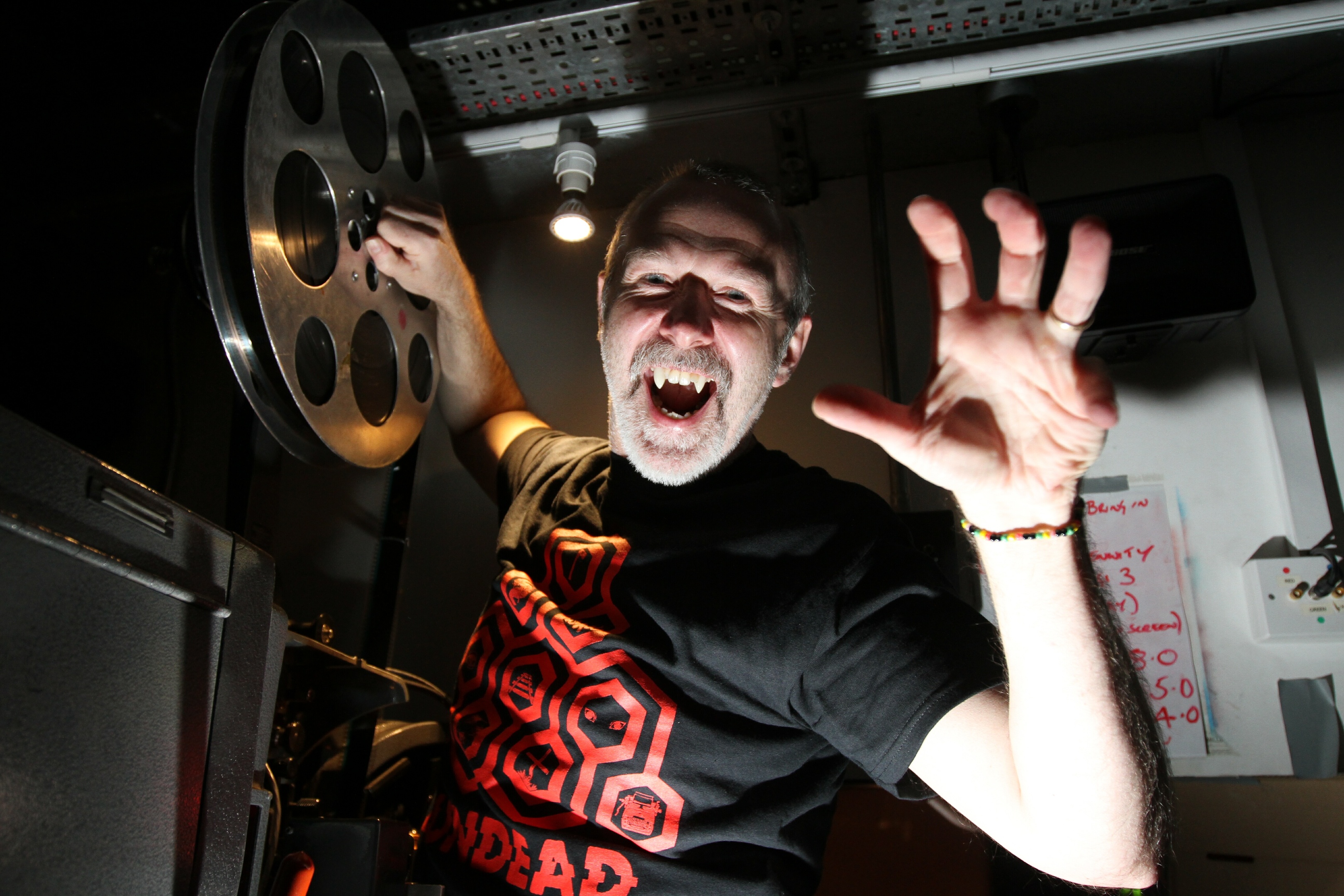 Head projectionist Ian Banks puts the first film reel on the projector