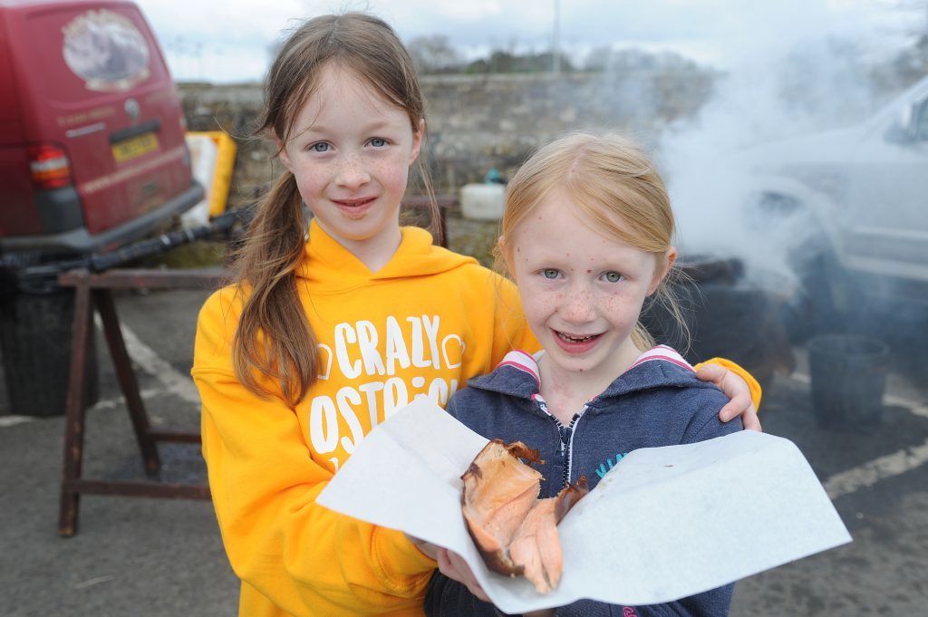 Lucy and Emily Smith with a smokie at St Andrews Farmers Market.