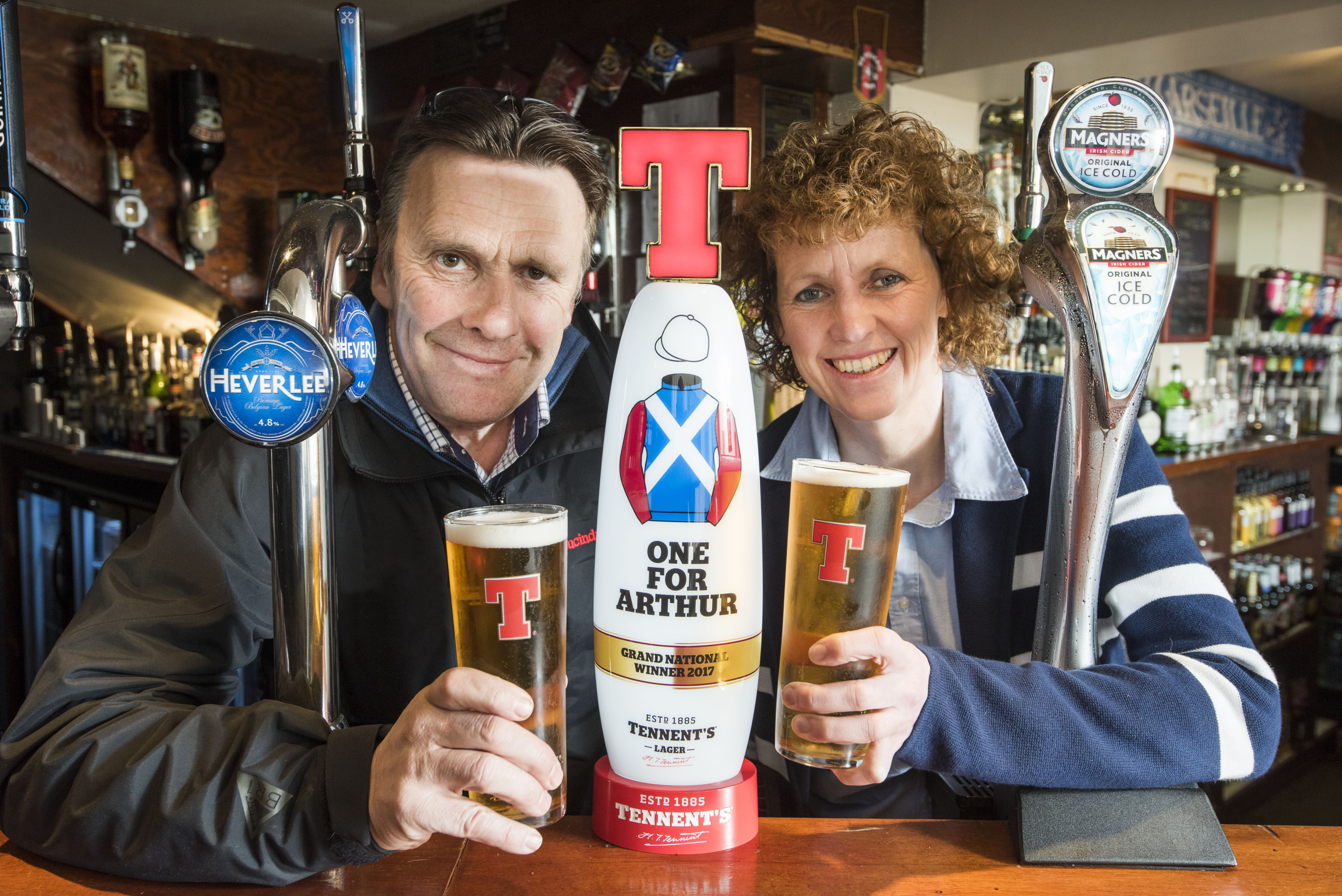 Lucinda Russell and Peter Scudamore with the Tennents special "One For Arthur" tap at the Thistle Hotel in Milnathort