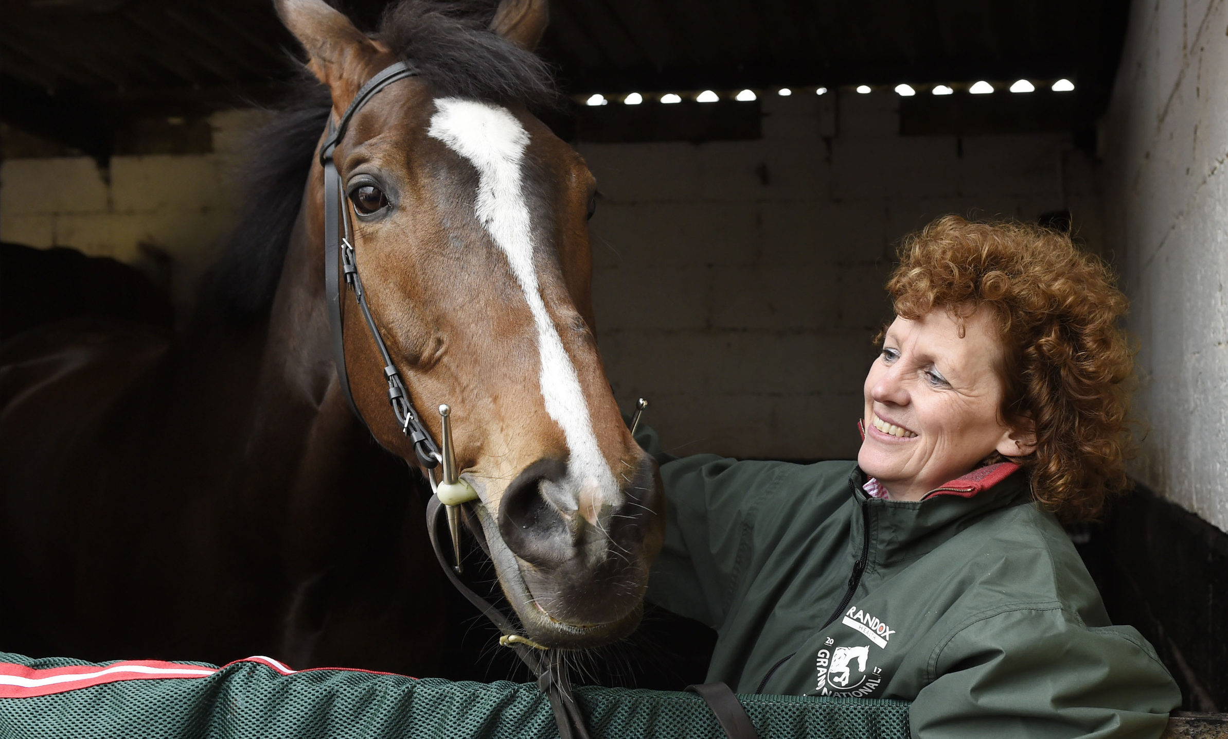 Grand National winner One For Arthur pictured with trainer Lucinda Russell at her yard.
