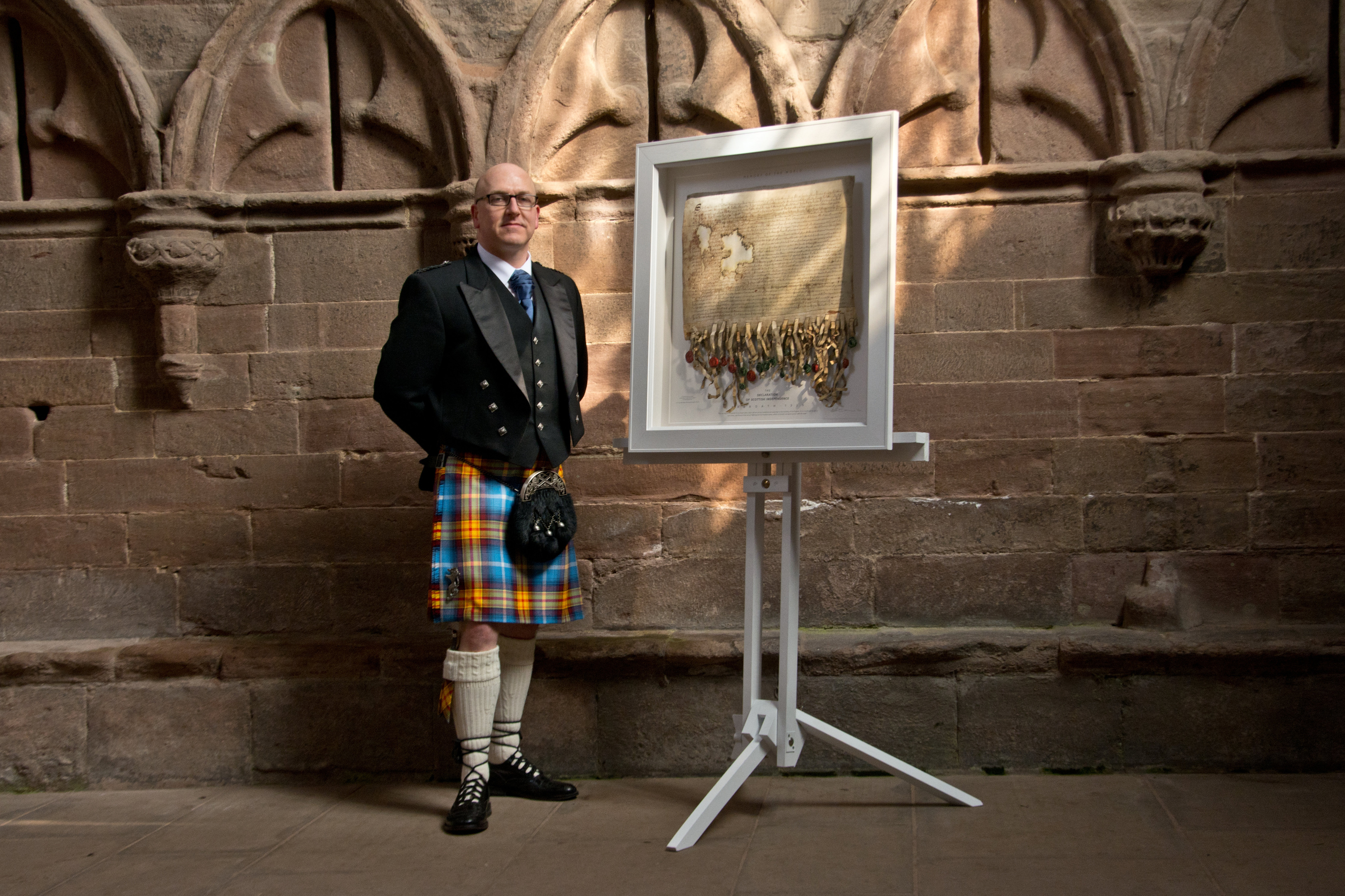 Artist Steven Patrick Sim with his replica of The Declaration of Arbroath at Arbroath Abbey.