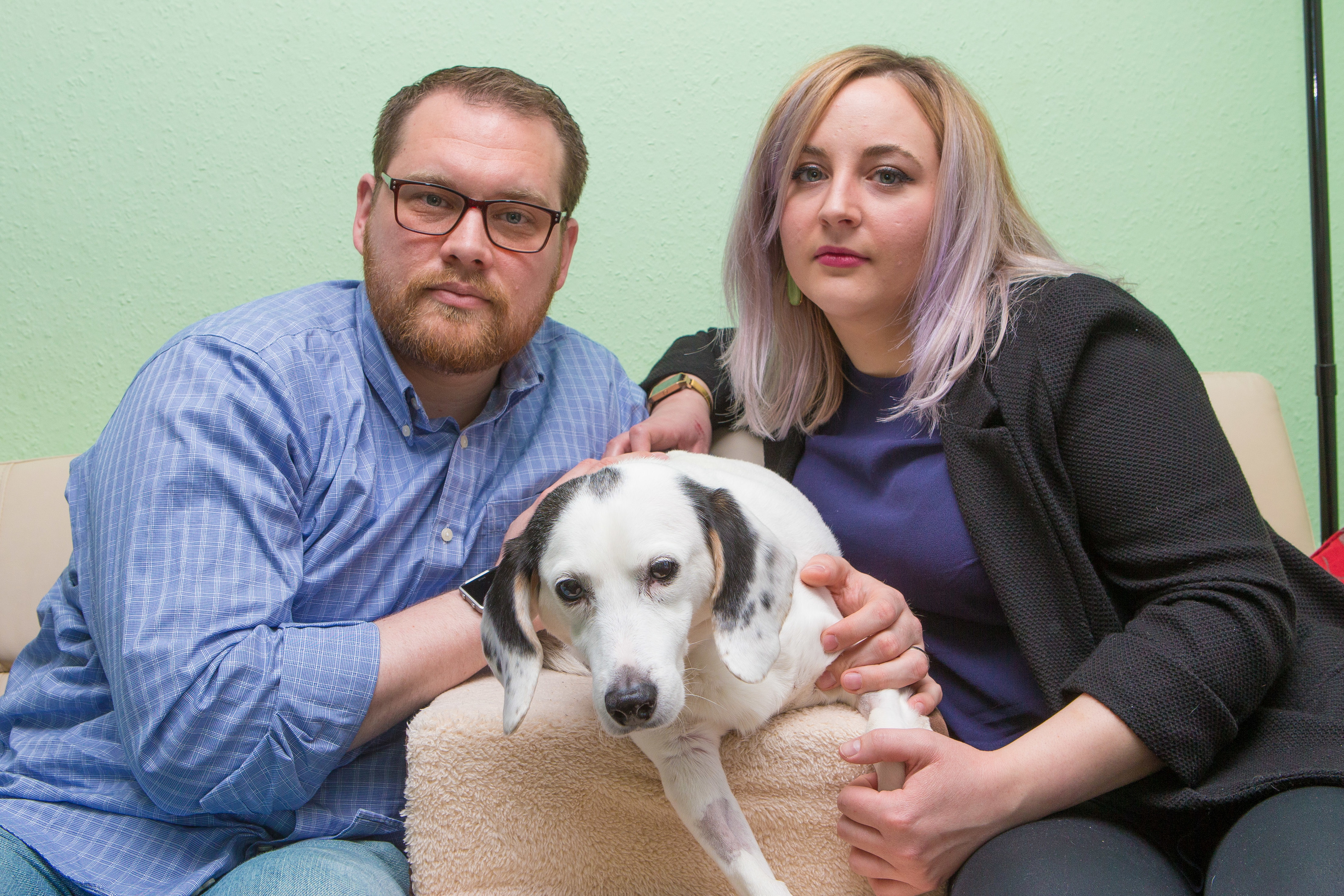 Diggery the service dog with his owners Kevin Nordby and wife Stephanie.
