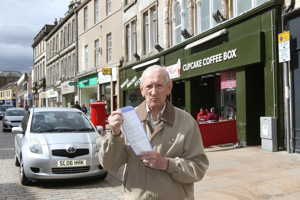 Tom Barnes, 91, in Kirkcaldy High Street, where he received his parking ticket.
