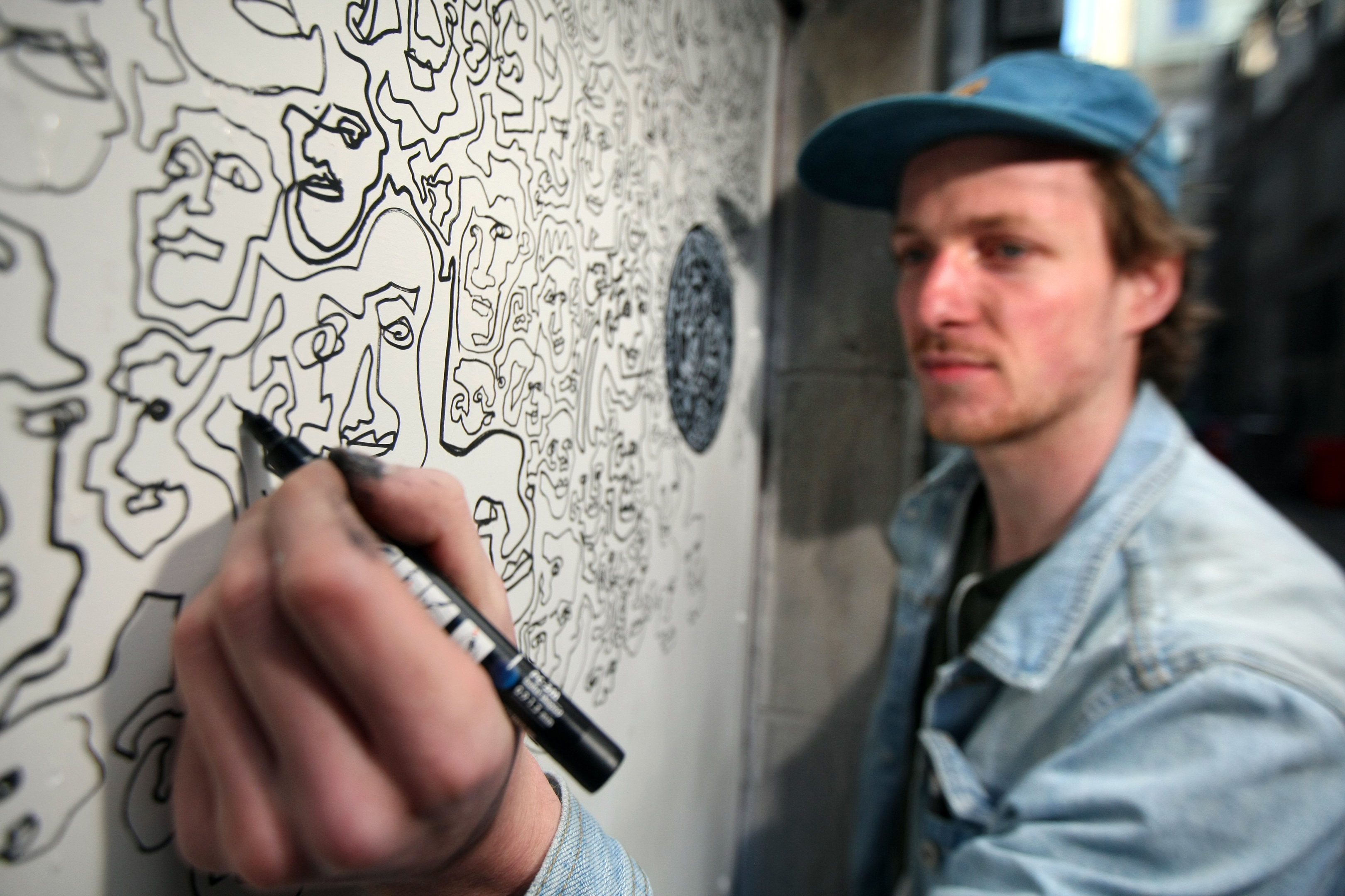 Gregor Thomson painting the rear exterior of the Quirky Coo in Couttie's Wynd.