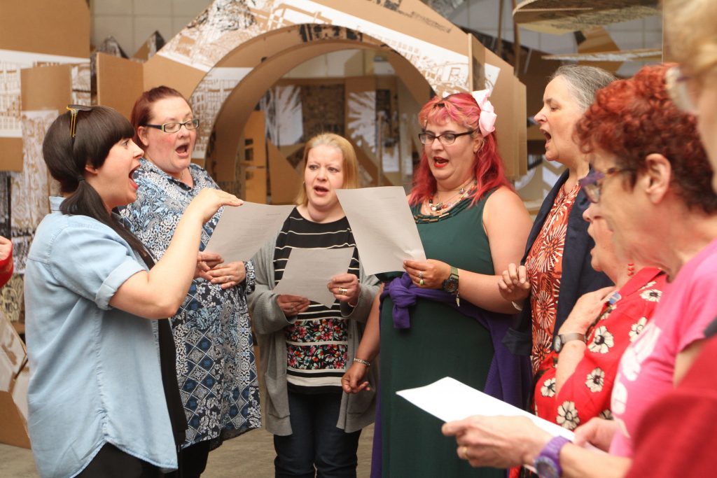 Alice Marra leads the Singer Machine Choir on Friday night.