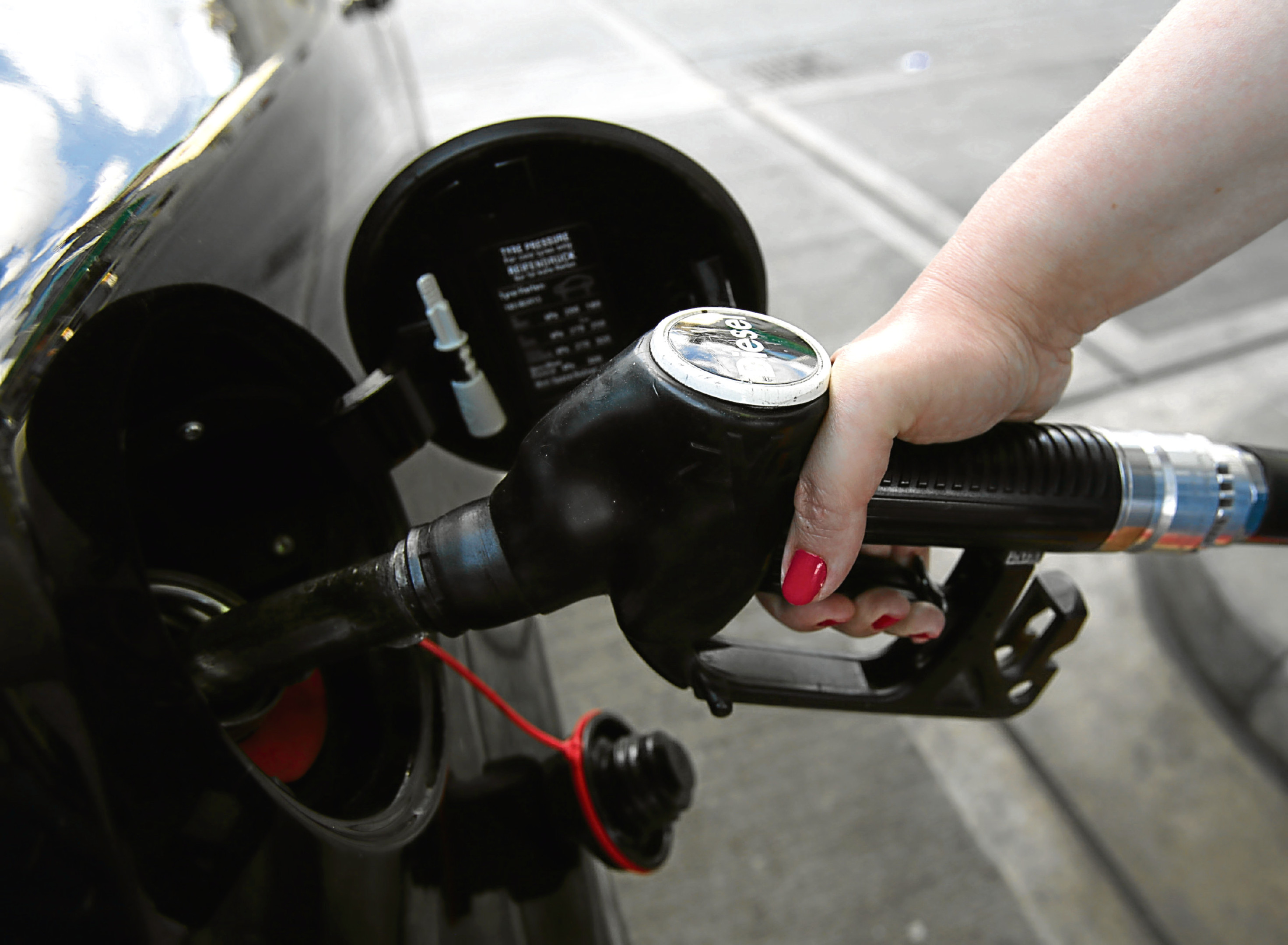 A car being filled up with diesel.