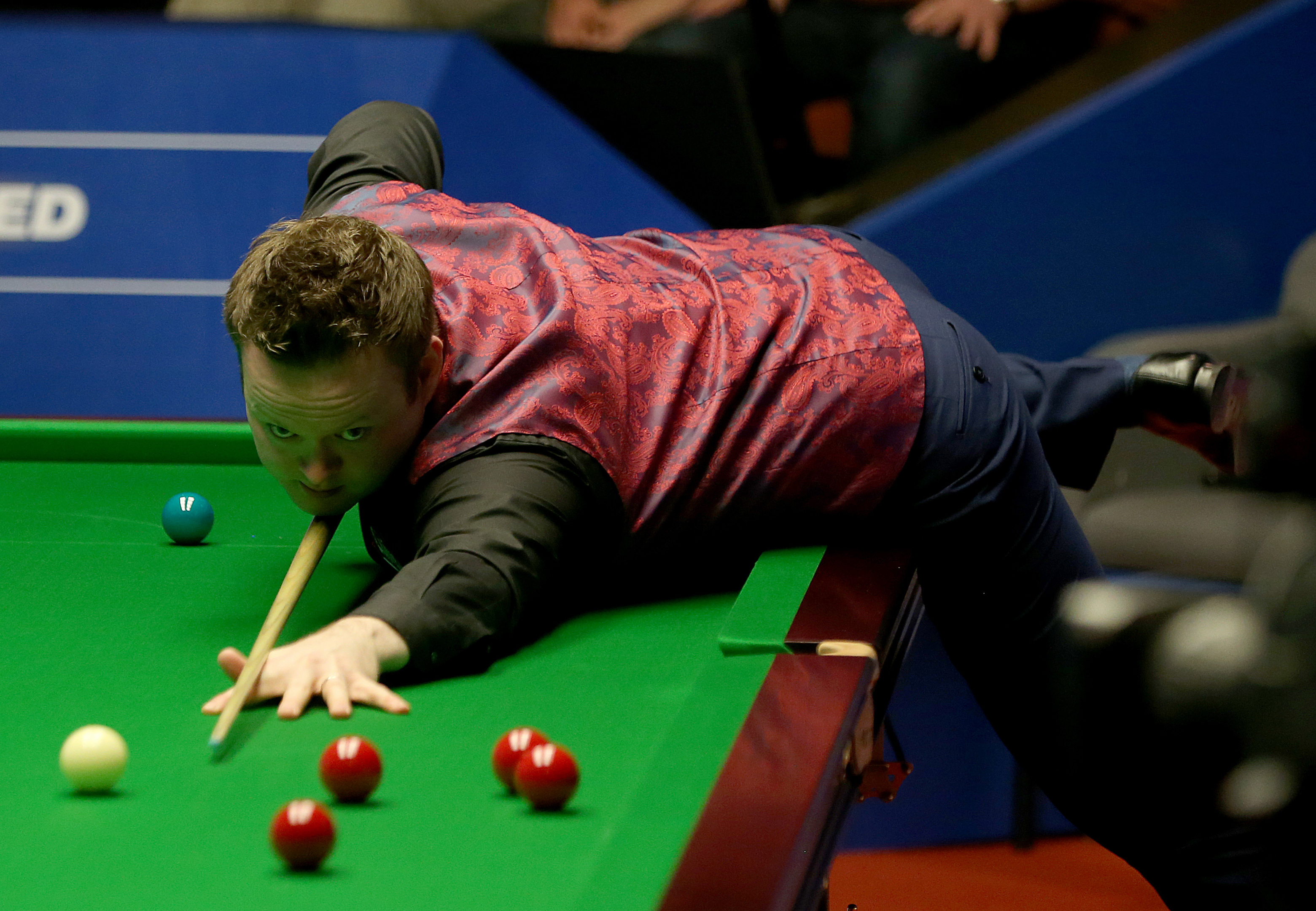 Shaun Murphy plays a shot against Ronnie O'Sullivan during their second round match of this year's World Snooker Championship.